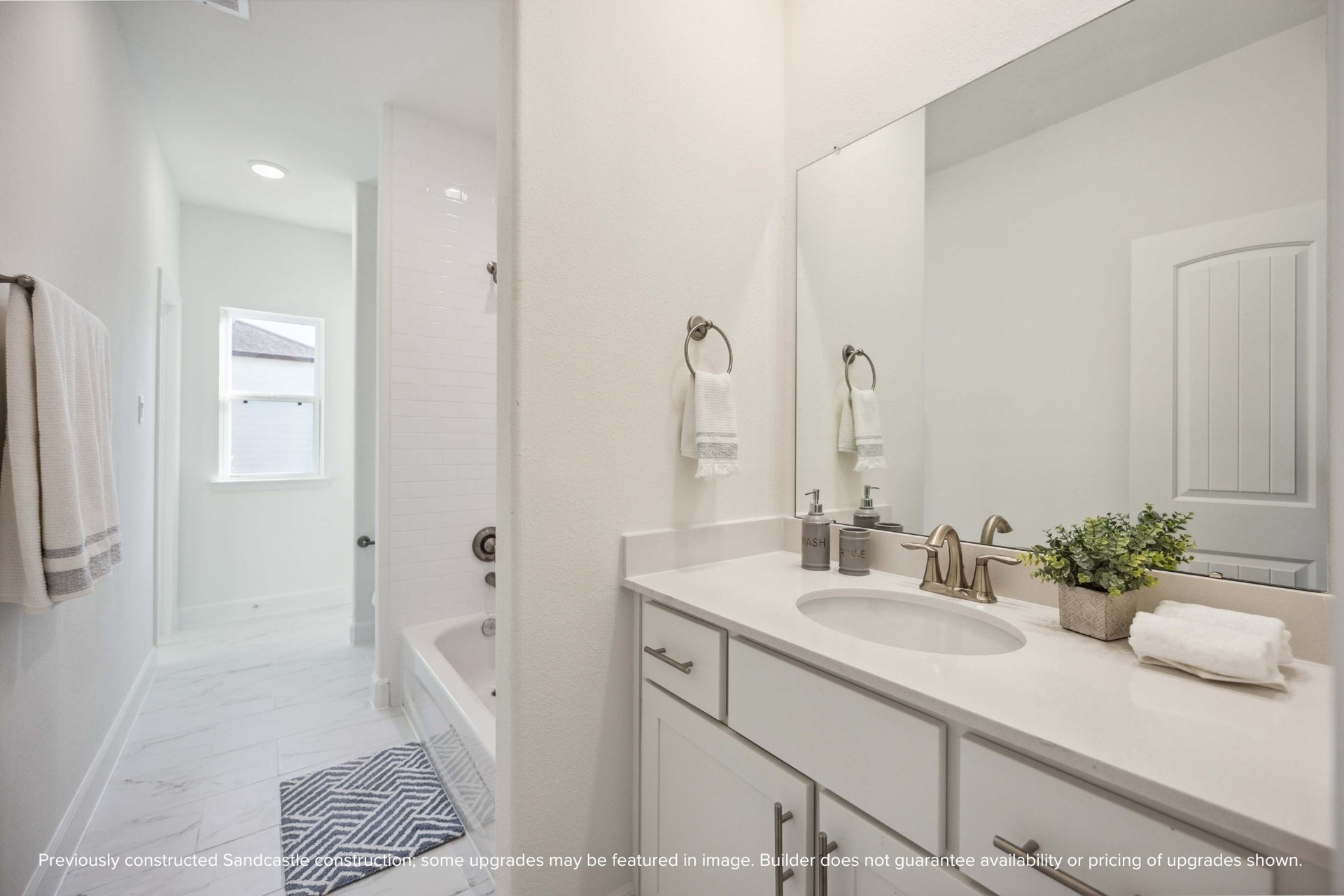 Flooded with light and finished with care, this hall bath delivers both function and finesse. Bonus points for that deep tub and elevated tilework.