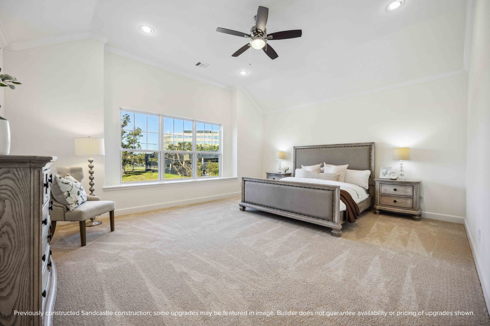 Step into a primary suite that lives like a luxury retreatsoaring ceilings, soft carpet underfoot, and a wall of windows bringing the outside in.
