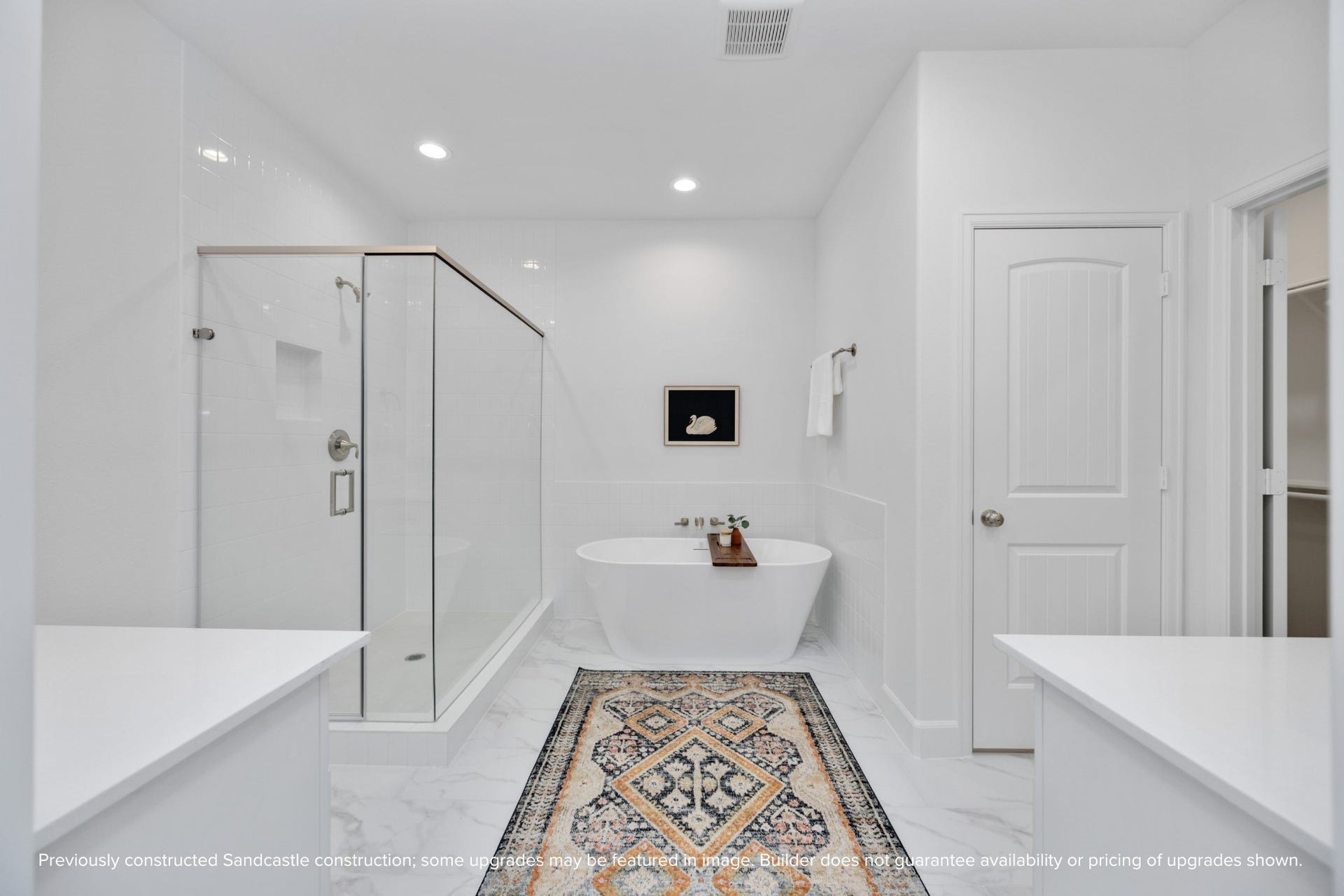 Soak away the stress of the day in your freestanding tub while your favorite playlist echoes off spa-white walls. This luxury en suite was made for unwinding.