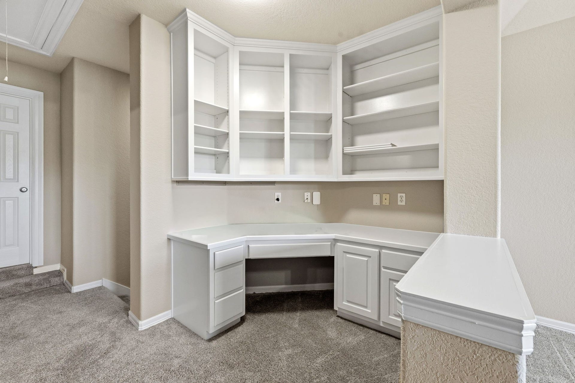 7514 Water Wood Trail, Kingwood, TX 77346 Bright and functional office nook upstairs with built-in shelving and cabinetry, perfect for organizing and productivity. Great for childrens homework station.