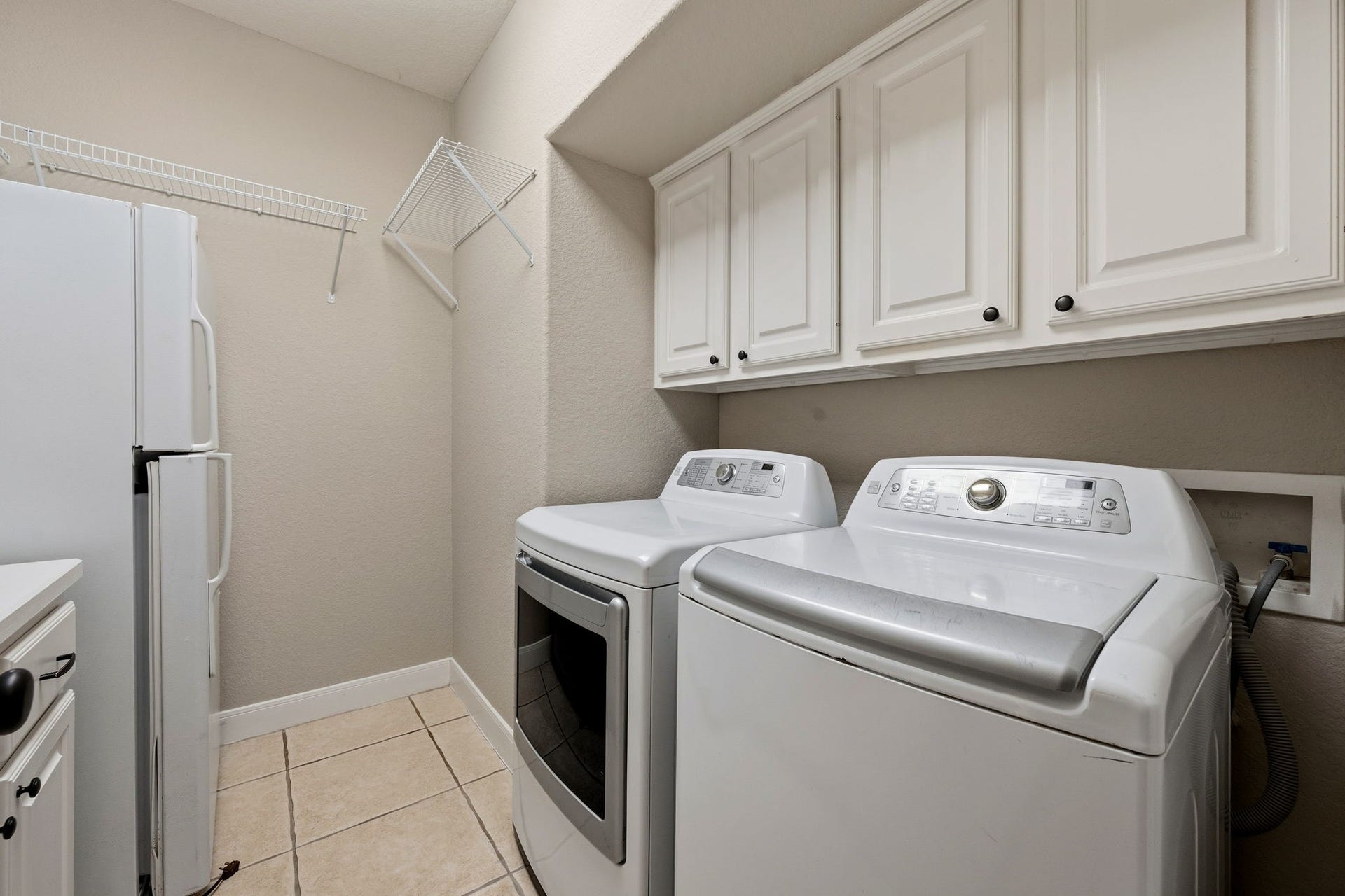 7514 Water Wood Trail, Kingwood, TX 77346 Spacious laundry room featuring modern appliances, ample cabinetry, and convenient shelving for organized storage.