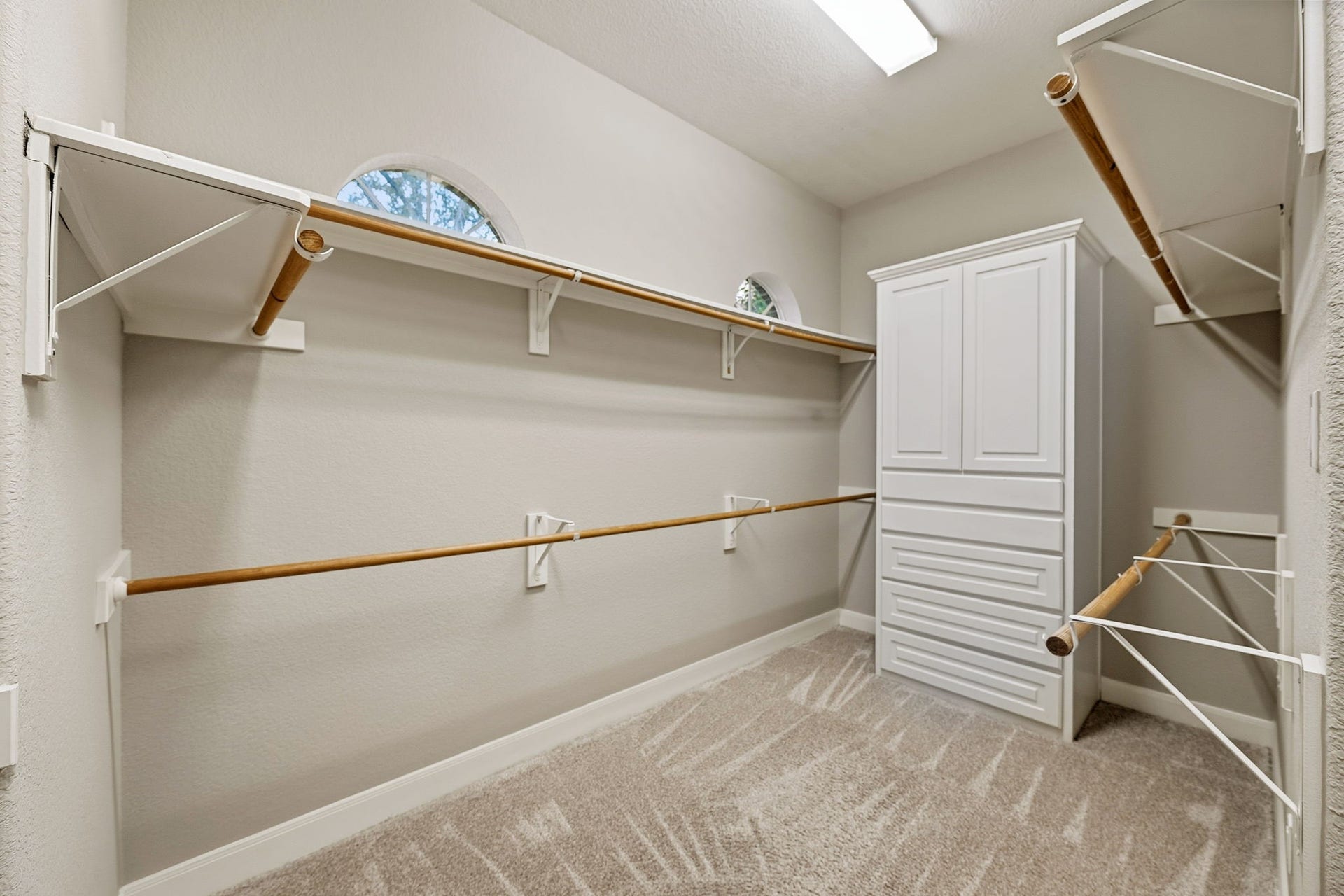 7514 Water Wood Trail, Kingwood, TX 77346 Spacious walk-in closet with ample shelving, hanging space, and a built-in storage unit, perfect for organizing your wardrobe.