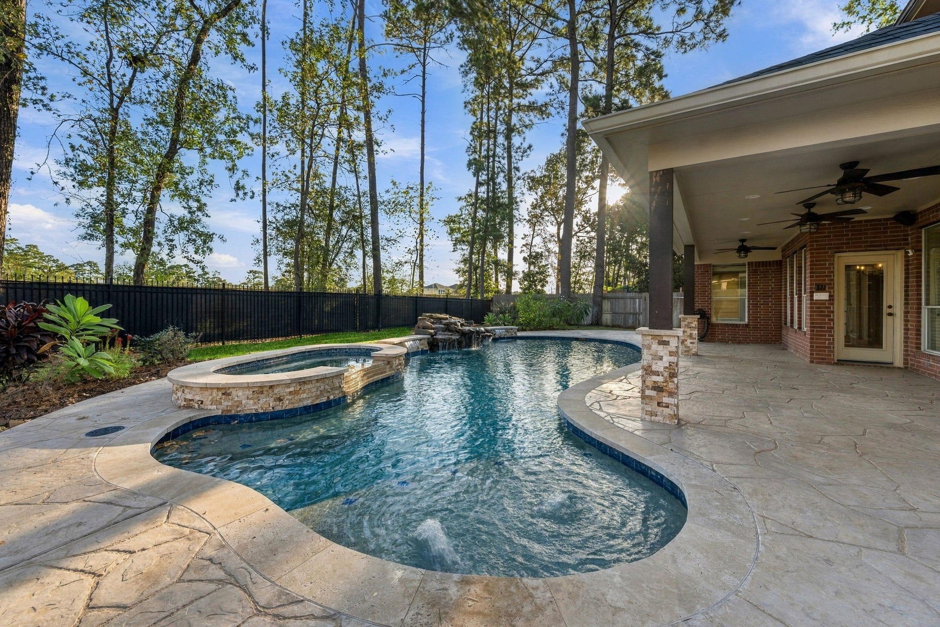 7514 Water Wood Trail, Kingwood, TX 77346 Experience luxury living with this stunning backyard oasis, featuring a sparkling pool, spa, and spacious covered patio perfect for entertaining.