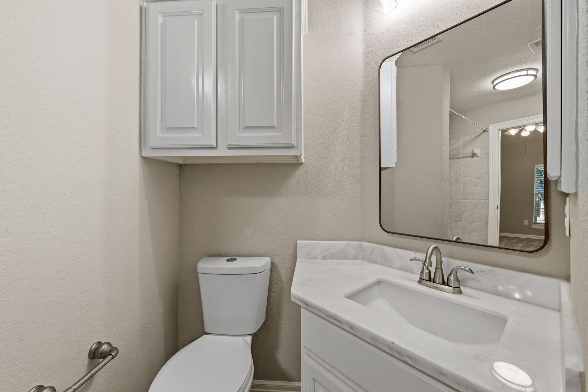 7514 Water Wood Trail, Kingwood, TX 77346 Charming bathroom featuring a sleek vanity with a updated countertop, ample cabinet storage, and stylish fixtures.