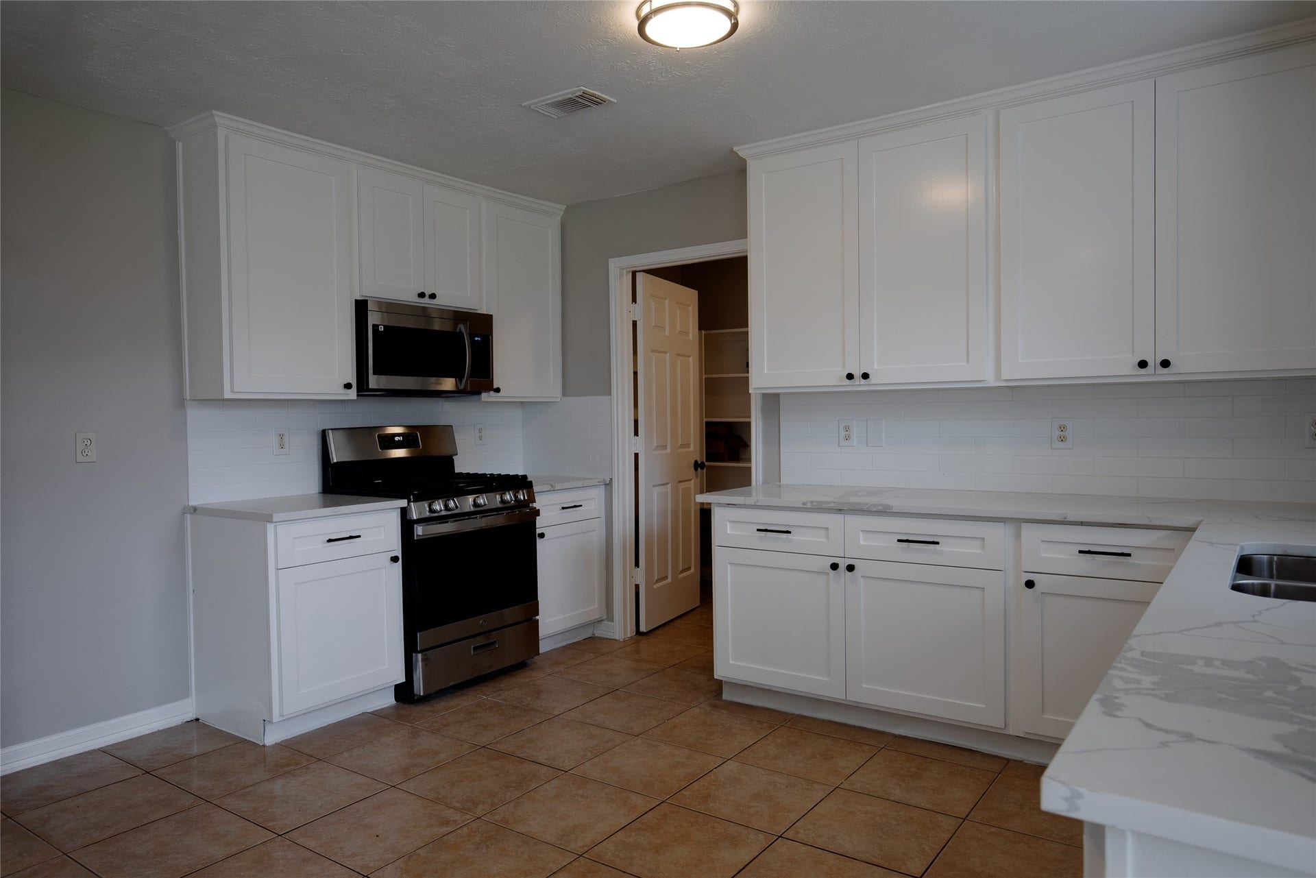 19946 Mason Creek Drive, Katy, TX 77449 Kitchen with new cabinets, quartz countertops, new range, microwave and dishwasher