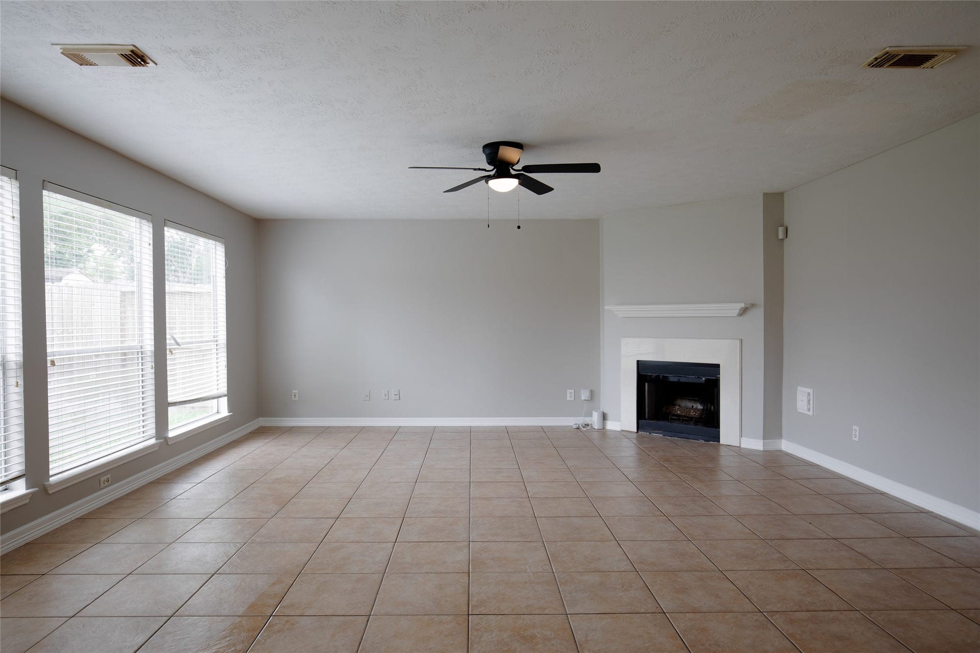 19946 Mason Creek Drive, Katy, TX 77449 den off kitchen with fireplace and backyard view
