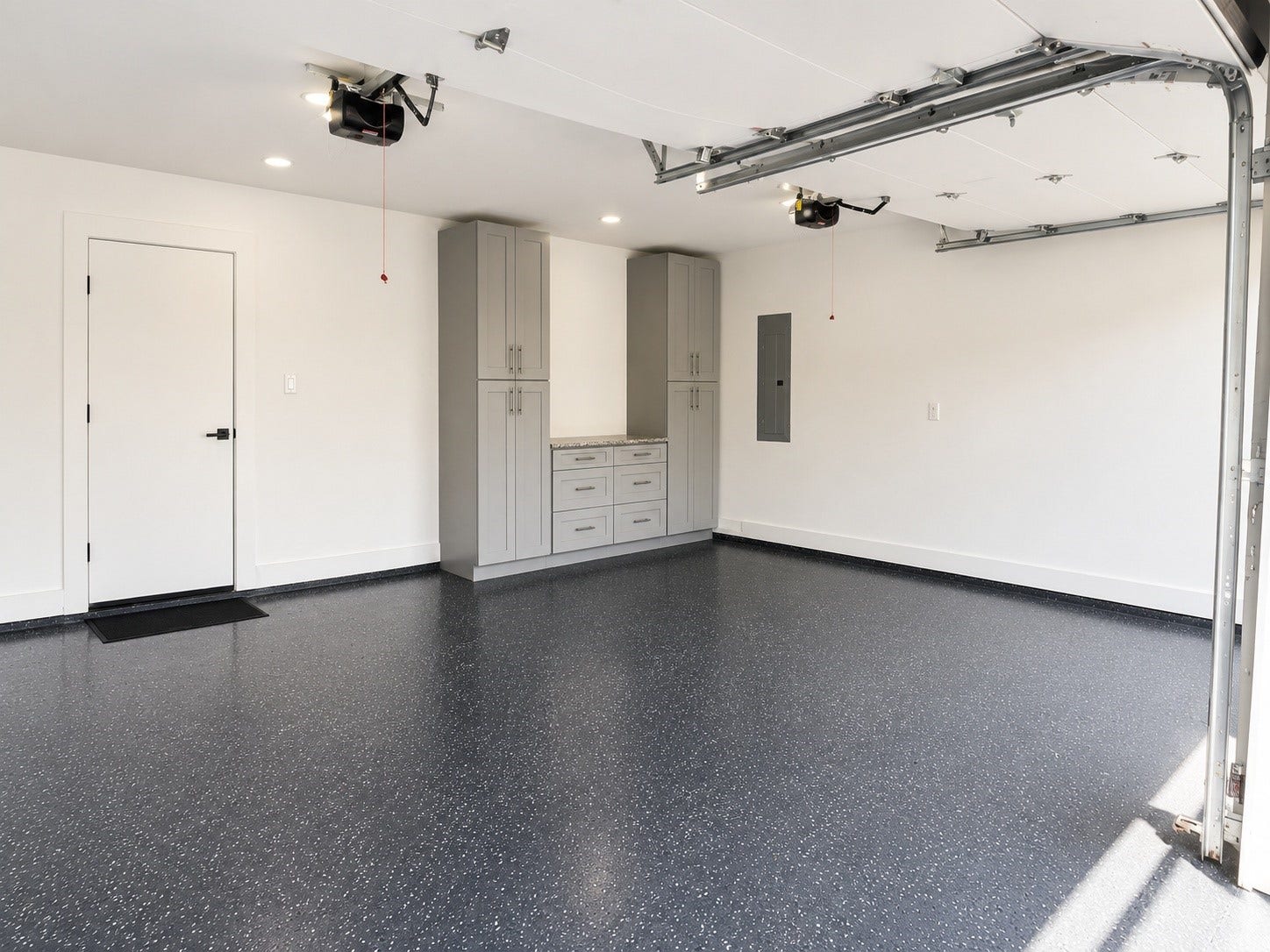 1207 Martin Street, Houston, TX 77018 Oversized two-car garage with epoxy flooring, custom built-in storage, and plenty of room for vehicles and a workspace.