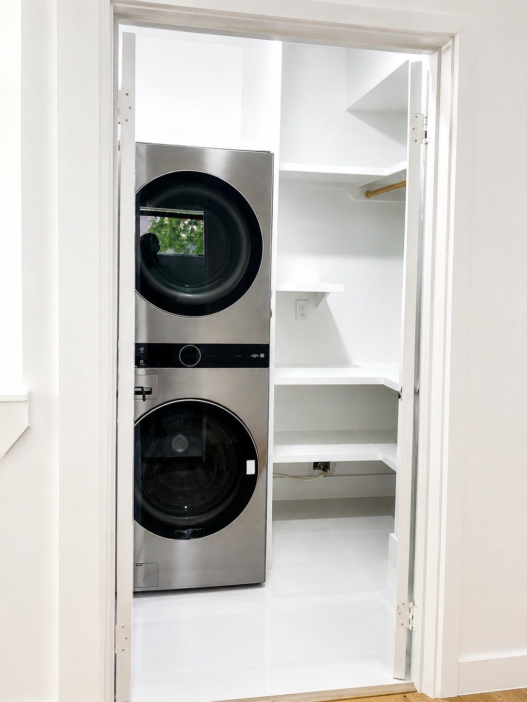 1207 Martin Street, Houston, TX 77018 Dedicated laundry room with built-in shelving and a full-size stacked washer and dryer.