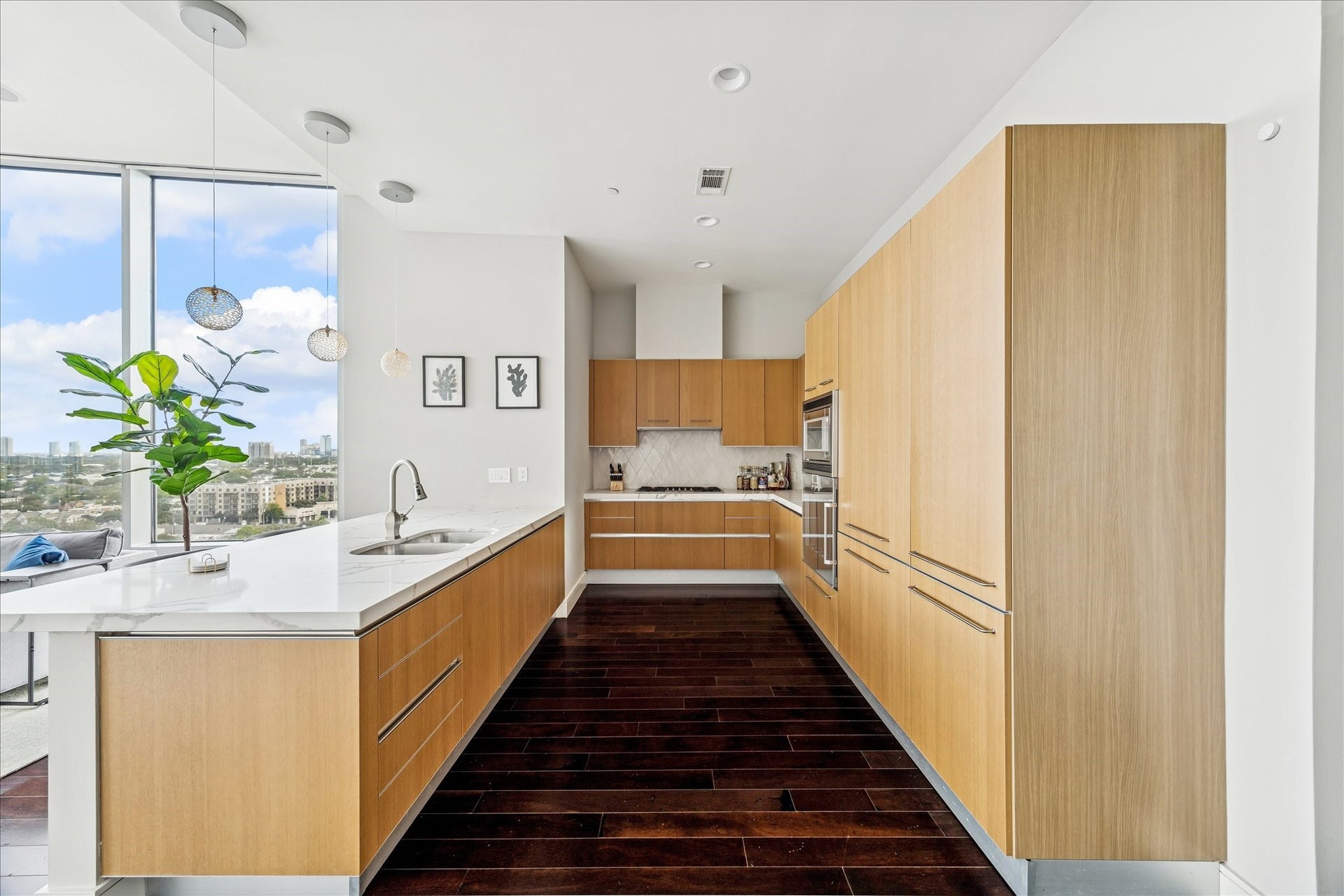 Kitchen features flat-panel cabinetry, quartz surfaces, built-in Gaggenau appliances, and hardwood flooring.