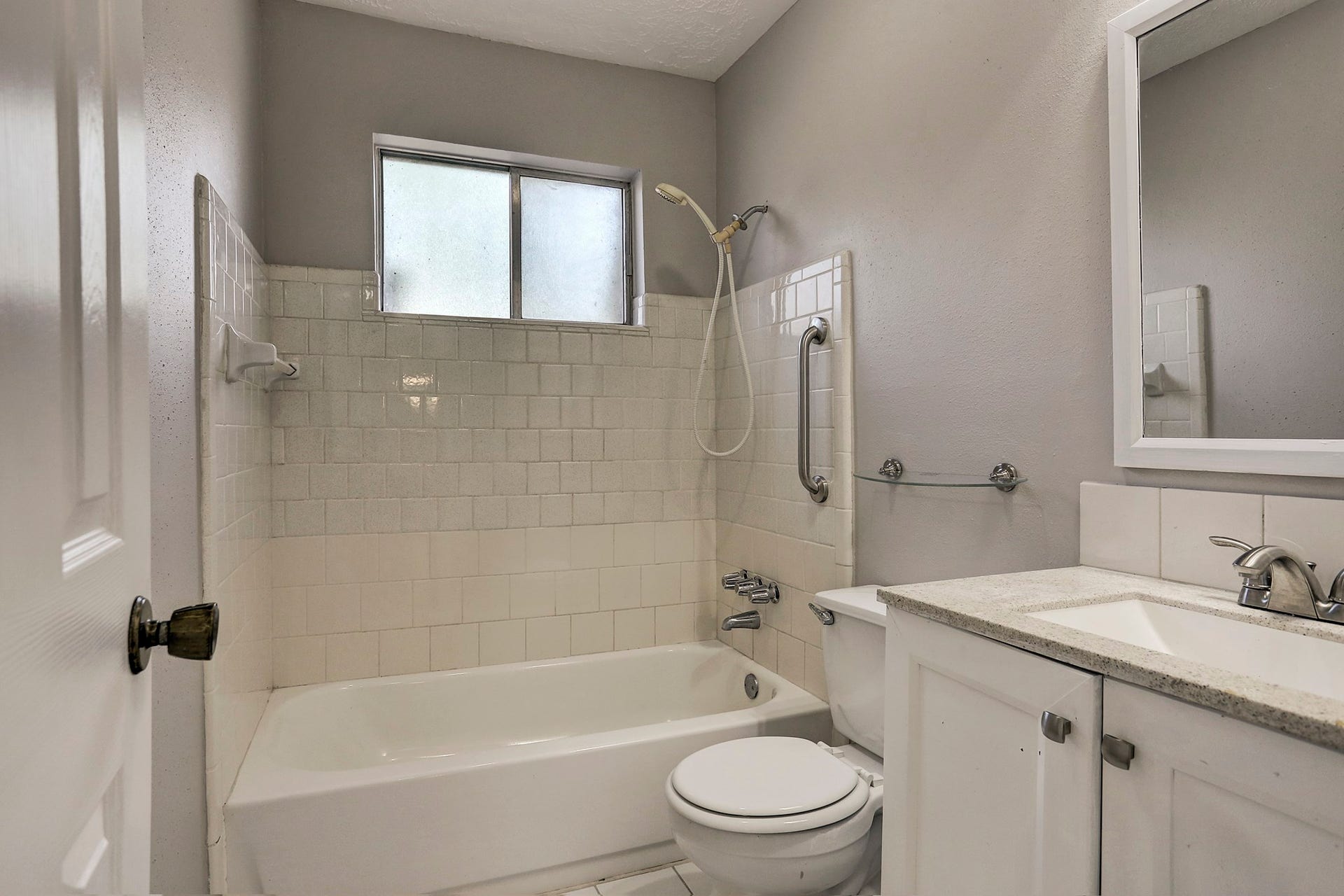 Immaculate baths with modern new fixtures & tile tub