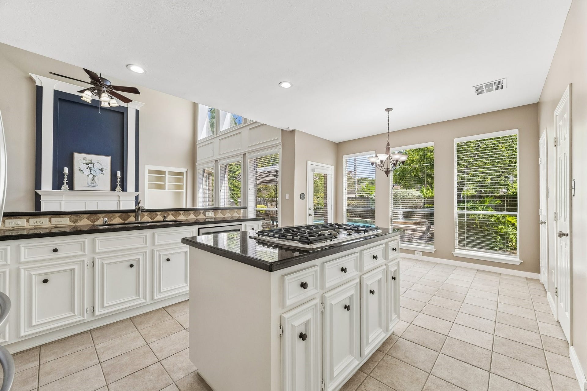 9618 Randon Lane, Missouri City, TX 77459 Gorgeous Kitchen with painted cabinets, GAS cooktop in the island and updated hardware.