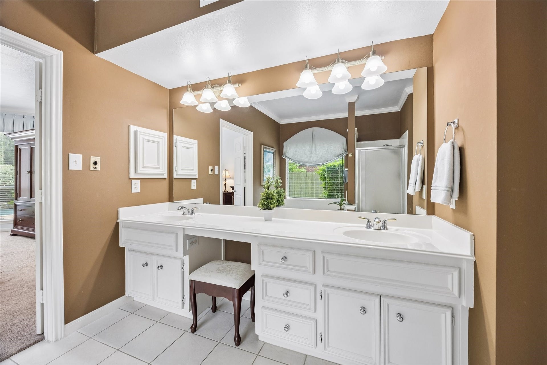 9618 Randon Lane, Missouri City, TX 77459 Updated lighting and hardware added to cabinets. Double sinks, seated vanity and medicine cabinet