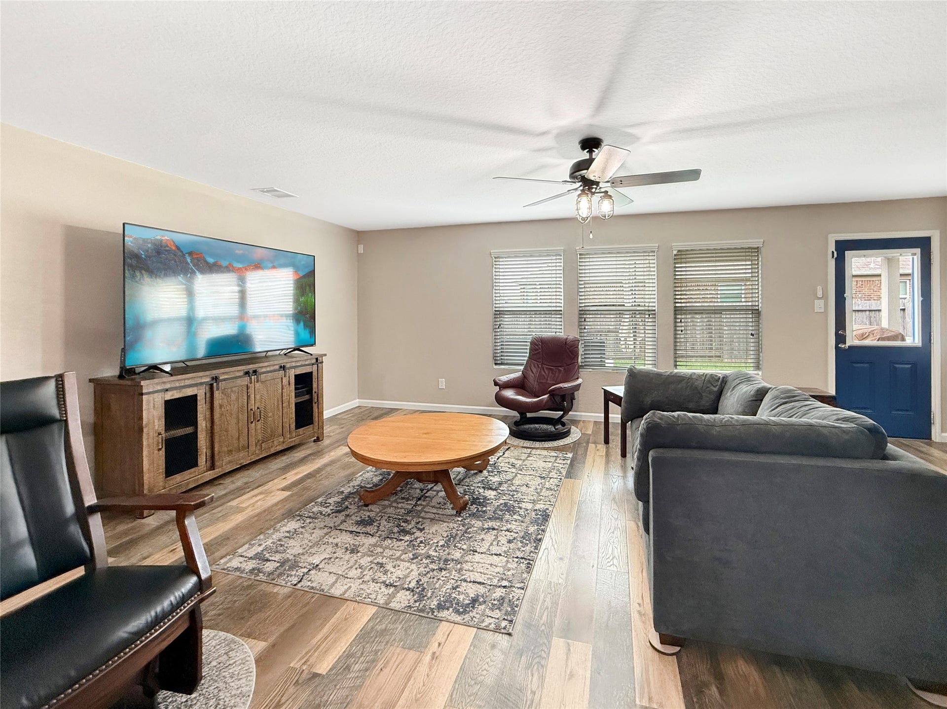 Open-concept living room with newer hard-surface flooringan inviting space for everyday relaxation and gathering with guests.