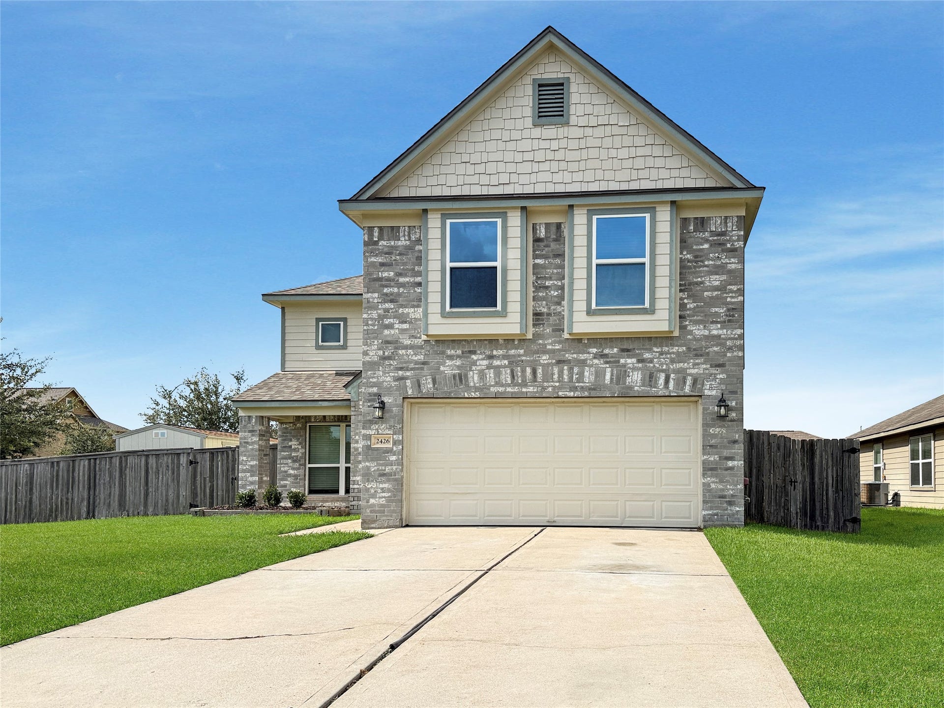 Bright, inviting exterior with charming curb appeal and a long driveway offering added parking spacea warm welcome home!