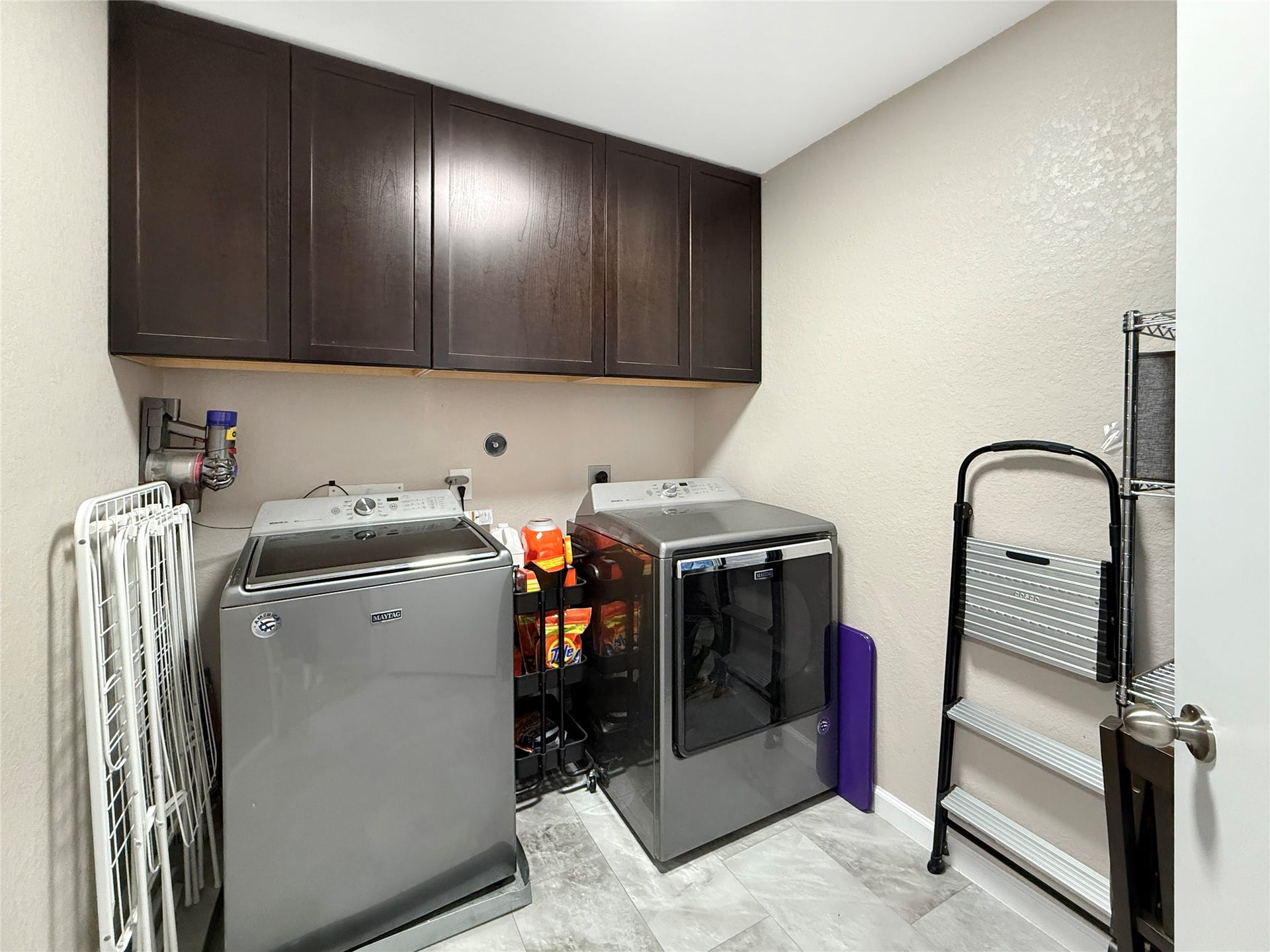 New built-in laundry room cabinets keep supplies organized and everyday essentials neatly tucked away.