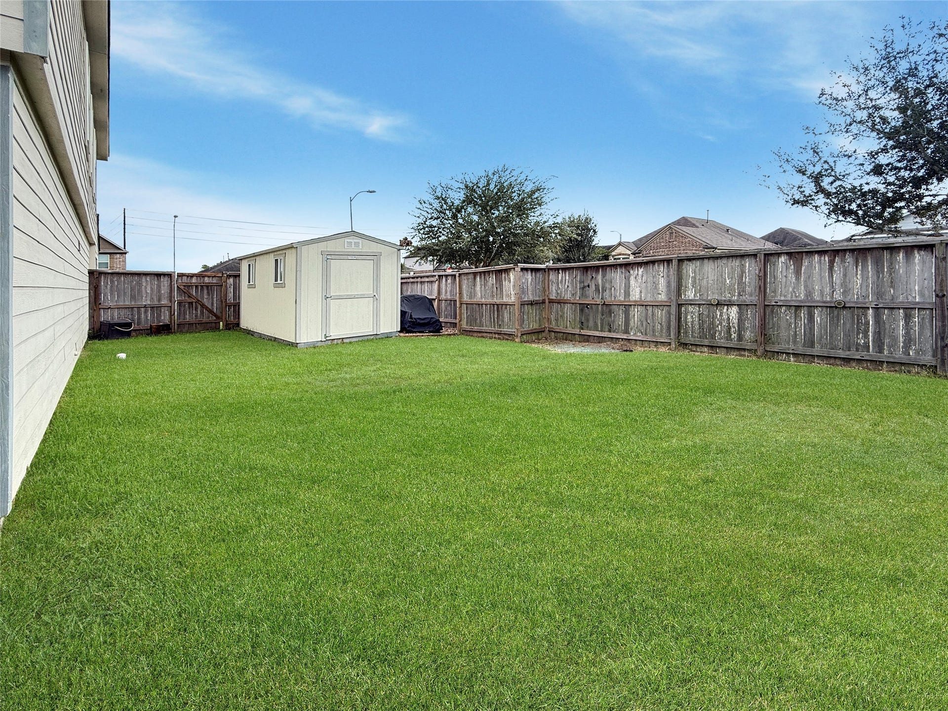 Spacious backyard offers room to play, garden, or create your own outdoor retreat, with a storage shed to keep tools and equipment organized.