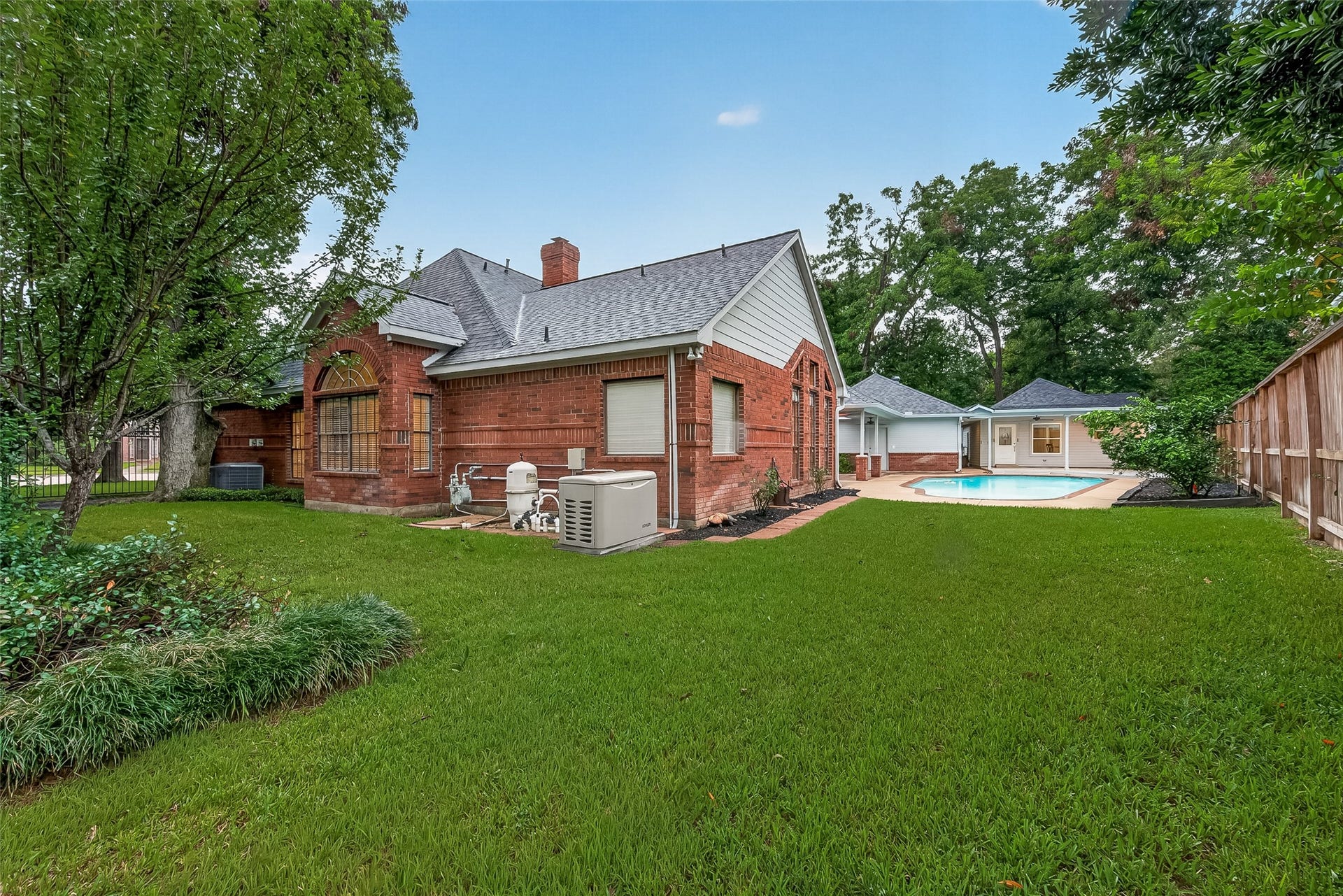 1410 Briar Green Court, Richmond, TX 77406 The Backyard is Huge and includes all this extra grass area in addition to the Pool and 650sqft guest Qtrs. Full House Generator too!