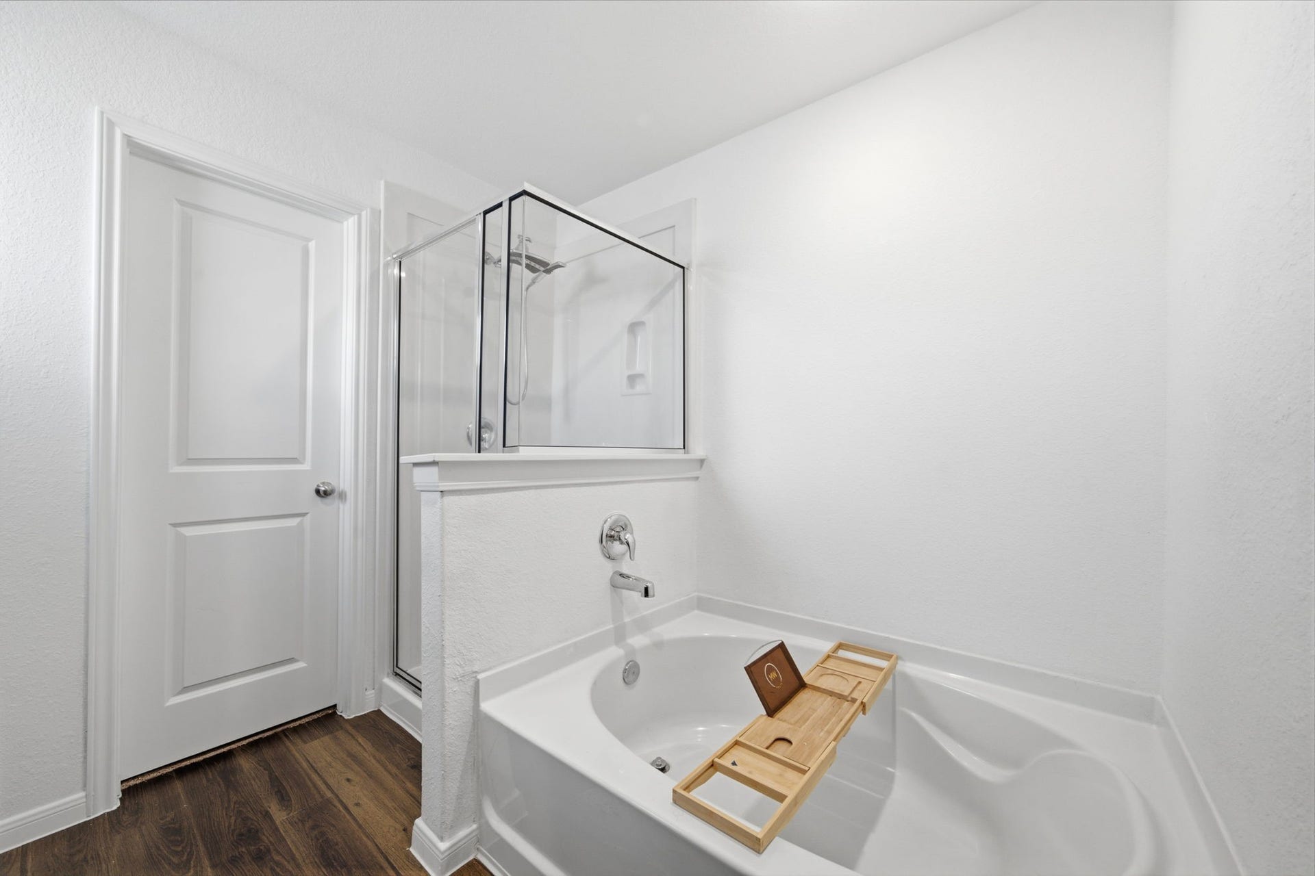 Primary bedroom ensuite with separate shower and soaking tub.