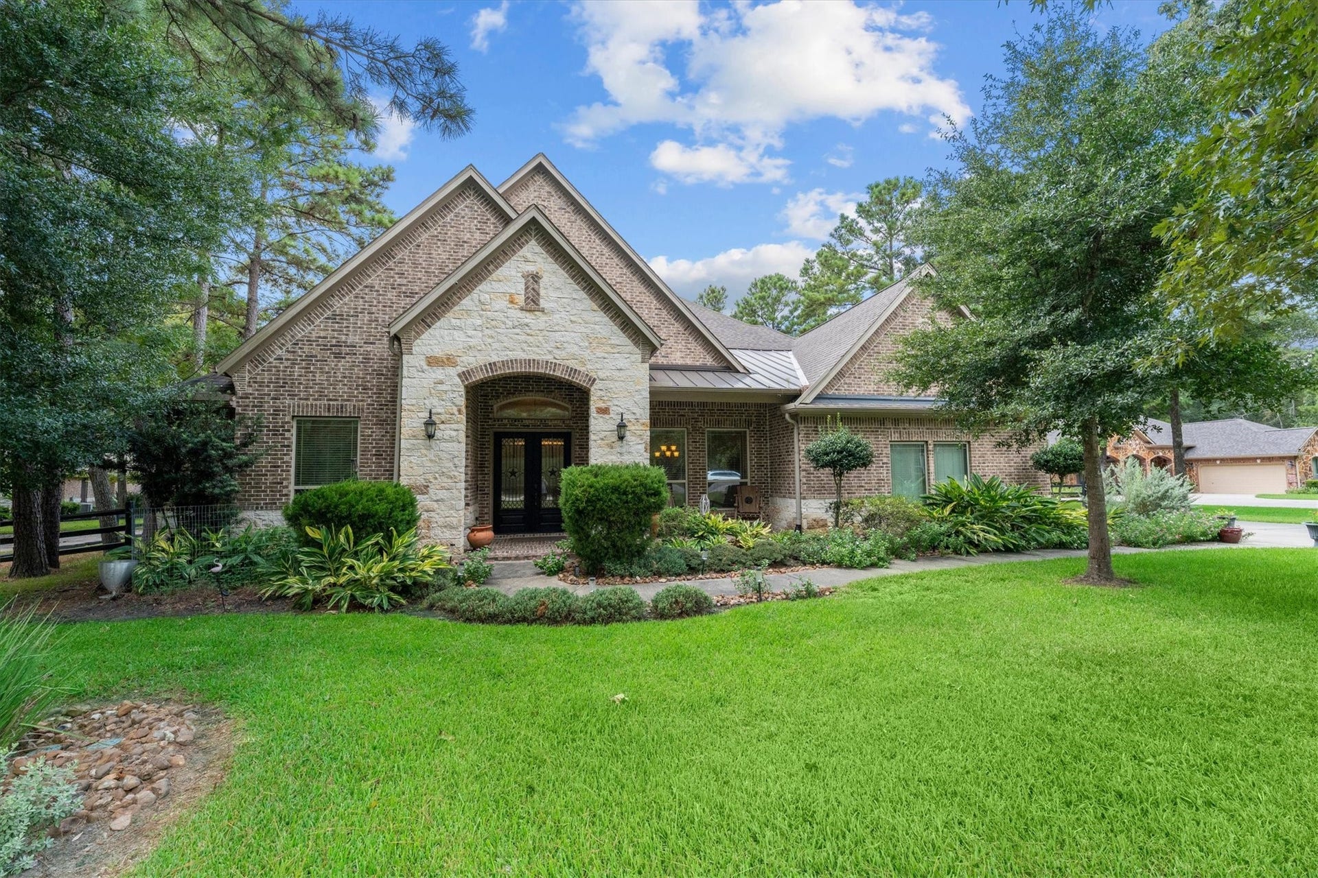 8938 Catamaran Way, Montgomery, TX 77316 Beautiful curb appeal and a tree-filled lot welcome you home to 8938 Catamaran Way. The home's brick and stone exterior pairs beautifully with the mature trees and established landscaping.