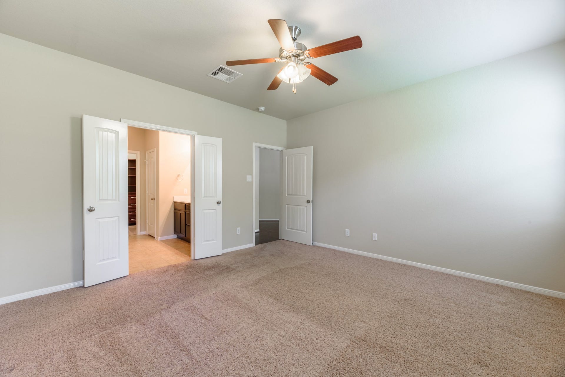 202 Black Swan Place, Magnolia, TX 77354 Alternate view of the primary bedroom has an en-suite bath with double doors.