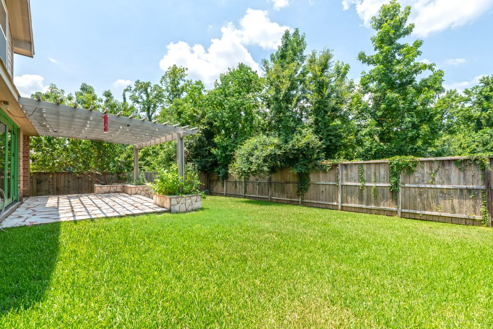 202 Black Swan Place, Magnolia, TX 77354 Fully fenced backyard with plenty of space for a playscape.