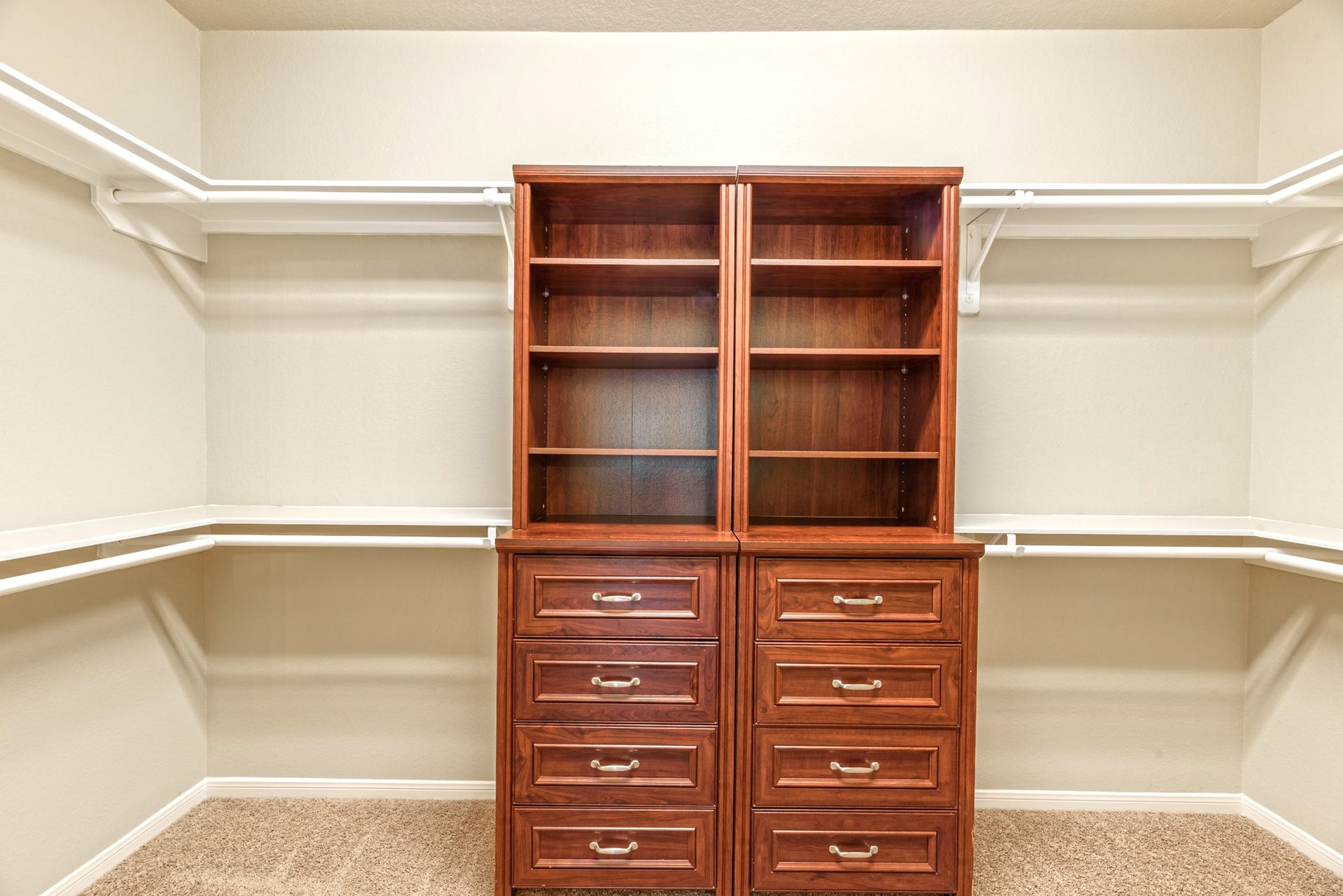 202 Black Swan Place, Magnolia, TX 77354 Spacious primary closet with custom built-ins. Plenty of hanging space, shelving, and drawers.