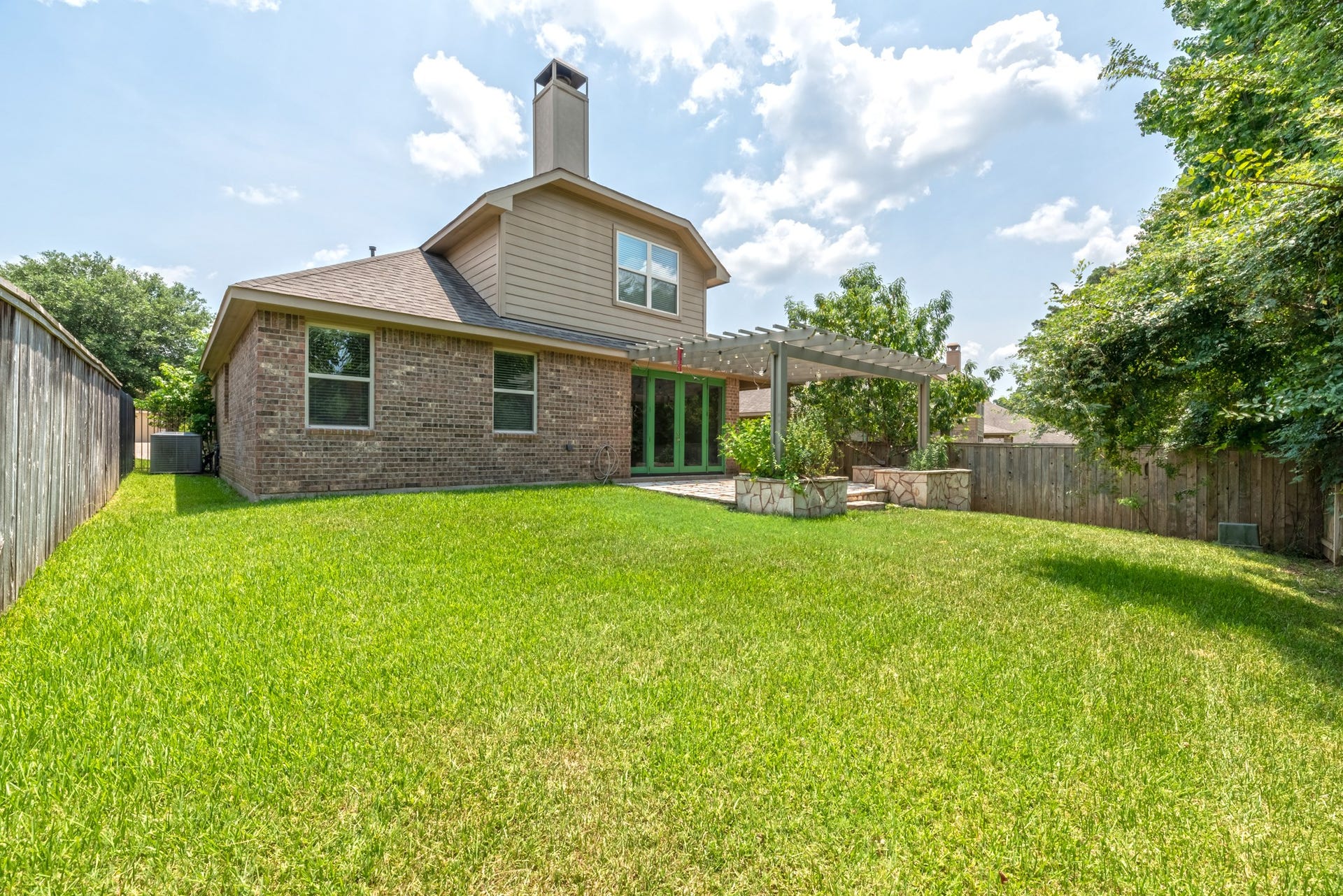 202 Black Swan Place, Magnolia, TX 77354 View showing the side yard and back elevation.