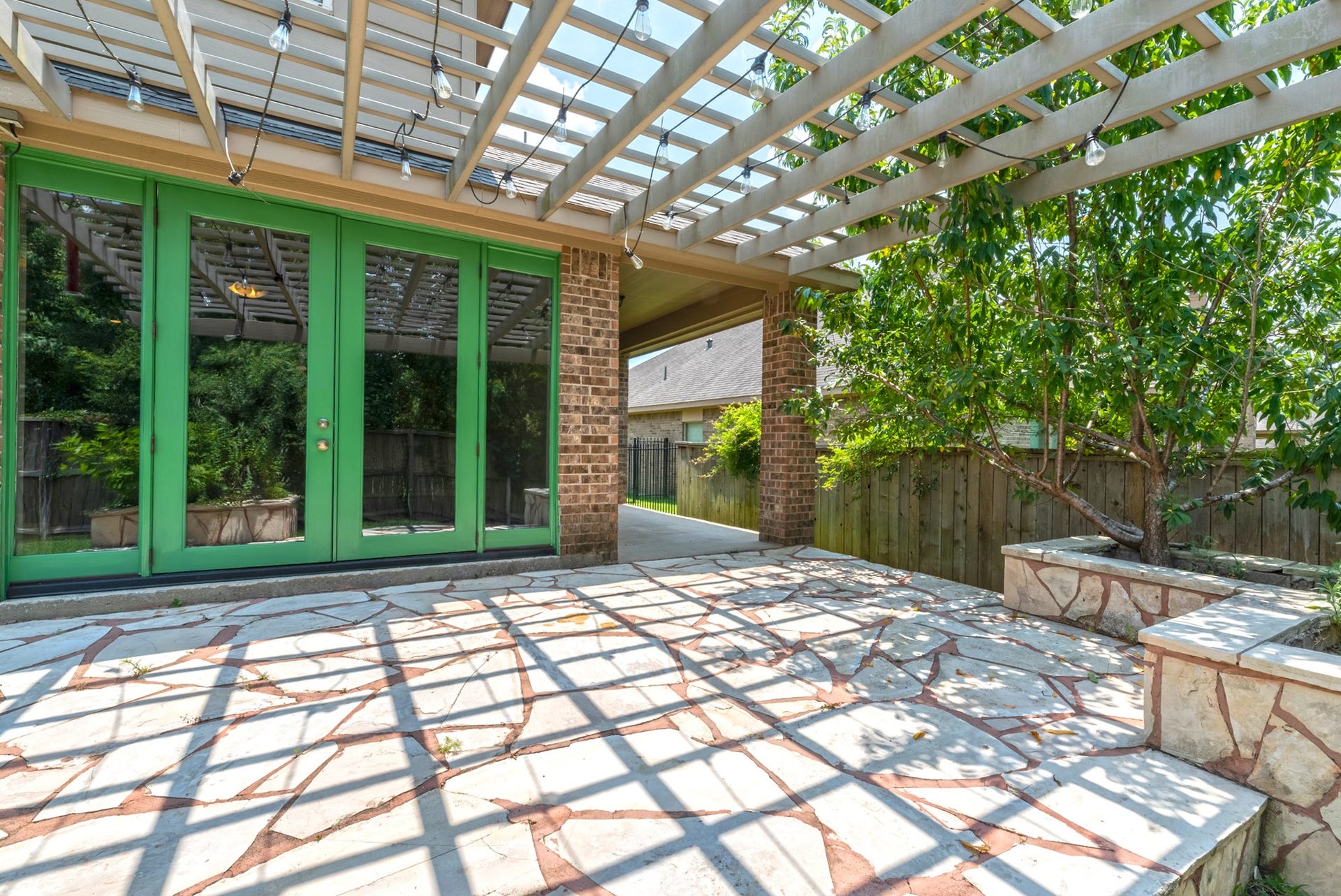 202 Black Swan Place, Magnolia, TX 77354 The pergola is great for shade and entertaining, there's even a covered side porch.