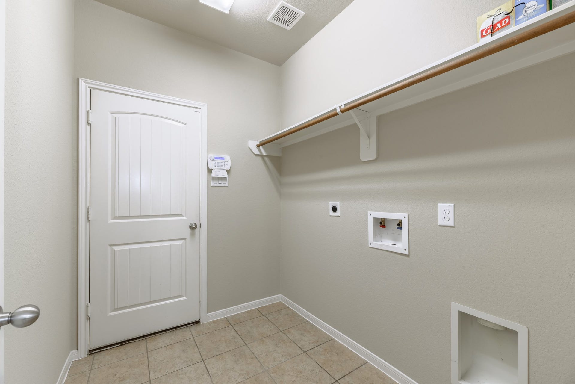 202 Black Swan Place, Magnolia, TX 77354 In house laundry room with hanging rack and shelf.