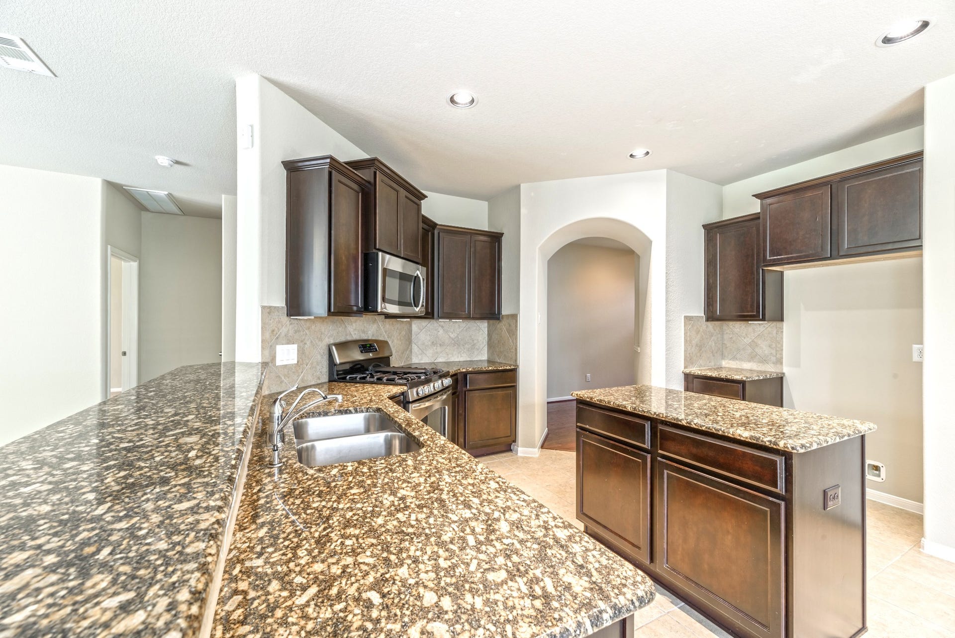 202 Black Swan Place, Magnolia, TX 77354 Under mount stainless steel sink, microwave above the stove, and storage under the island. The bar has plenty of room for bar stools to entertain while you cook.