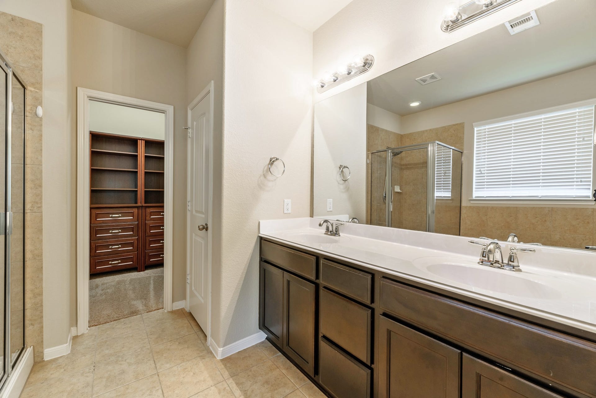 202 Black Swan Place, Magnolia, TX 77354 His and hers vanity with plenty of storage cabinets and pull drawers. Standing shower, garden tub, and separate commode.