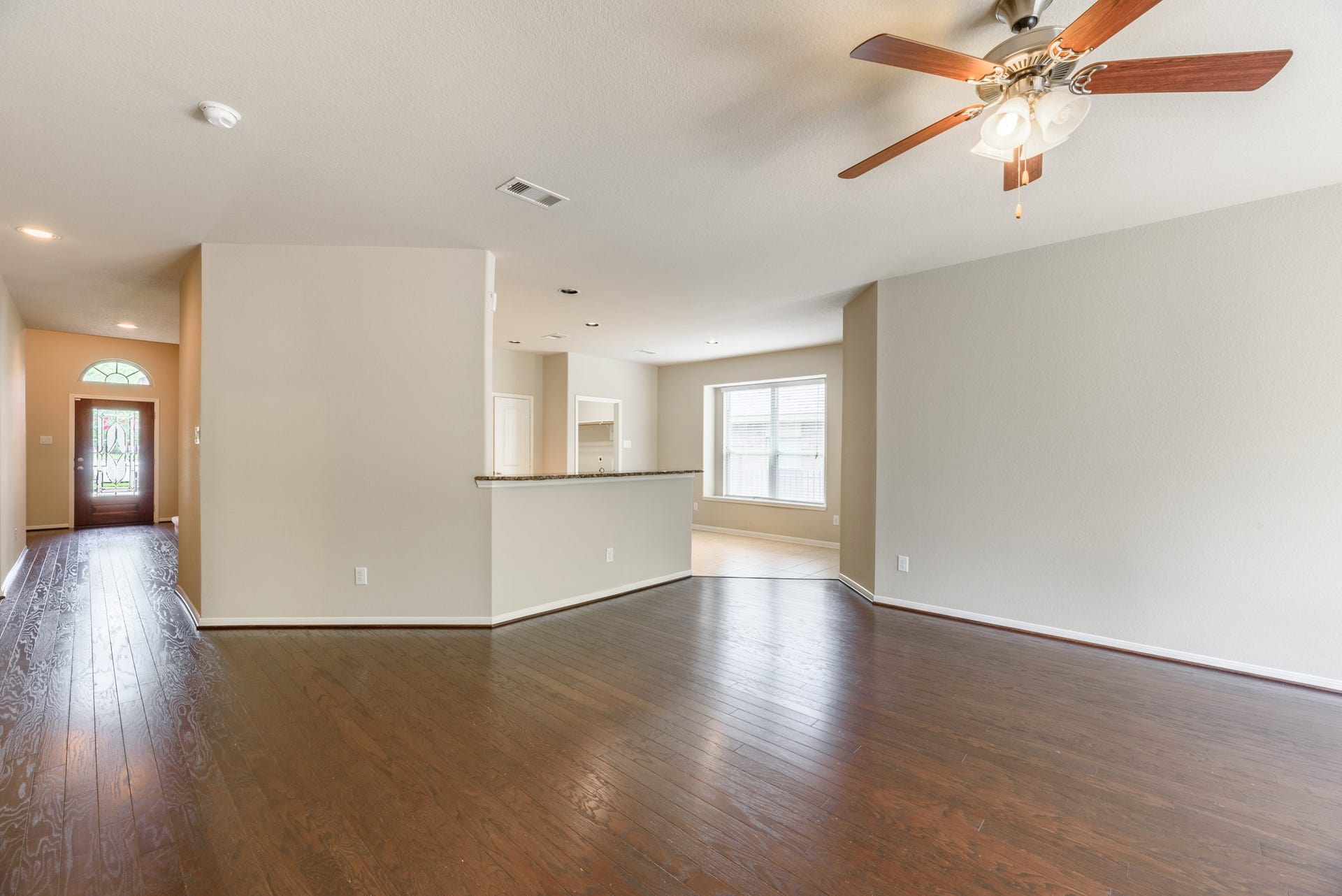 202 Black Swan Place, Magnolia, TX 77354 Living room view looking towards the kitchen and breakfast area with bar.
