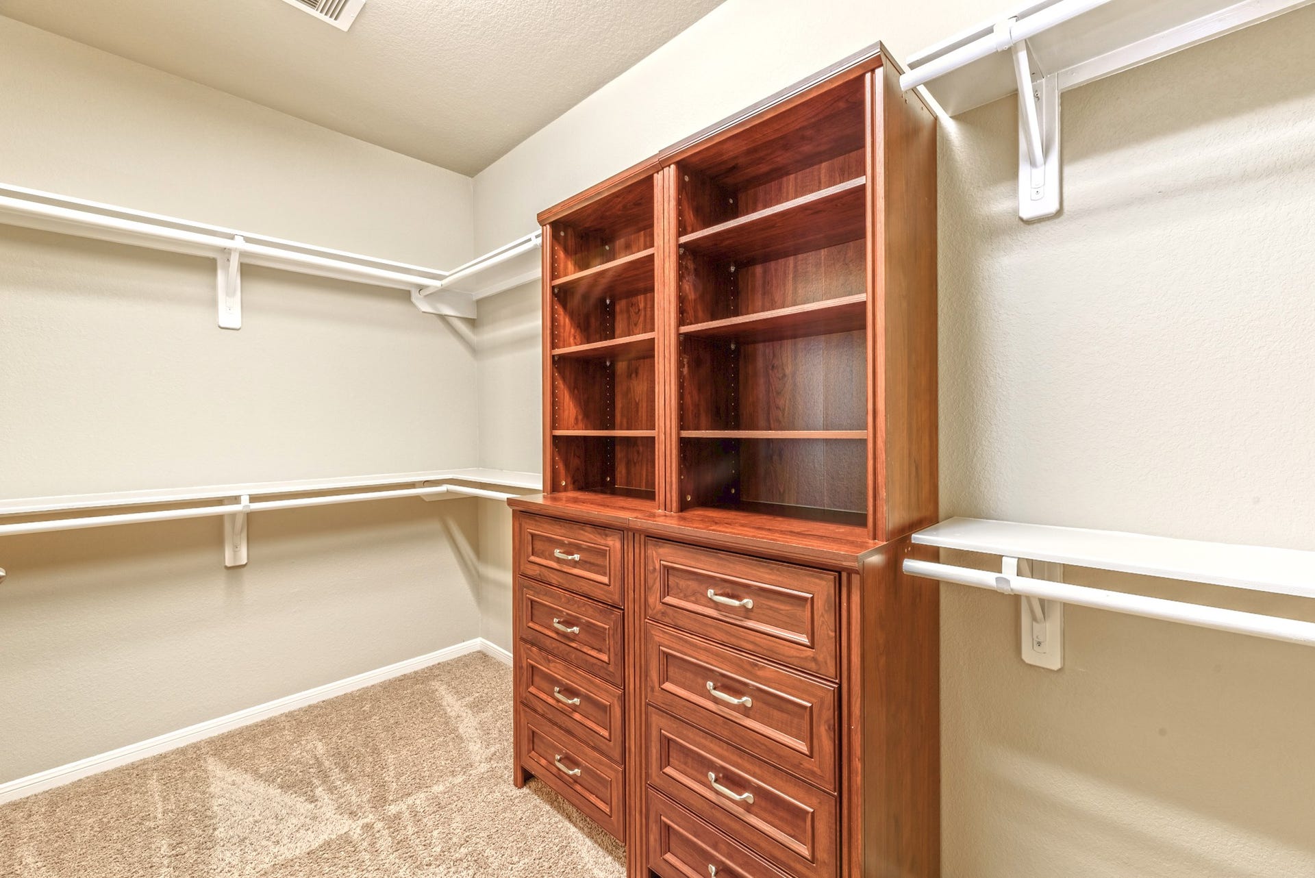 202 Black Swan Place, Magnolia, TX 77354 Lower and upper hanging spaces with shelving in the oversized walk-in closet.