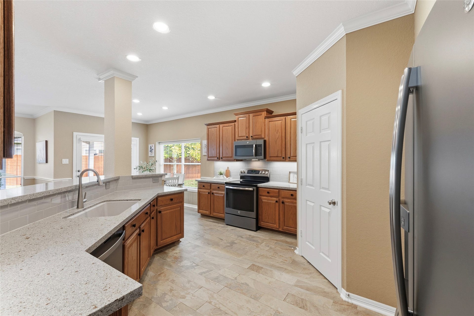 15314 Ledgewood Park Drive, Cypress, TX 77429 Updated kitchen inlcudes Quartz countertops, Kohler cast iron undermount sink, subway tile backsplash, updated faucet, and under-cabinet lighting.