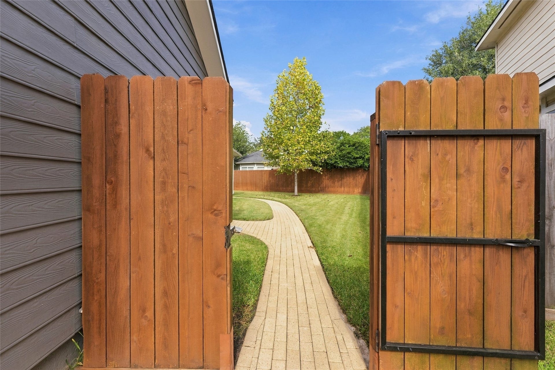 15314 Ledgewood Park Drive, Cypress, TX 77429 Brick walkway leads to a gorgeous backyard.