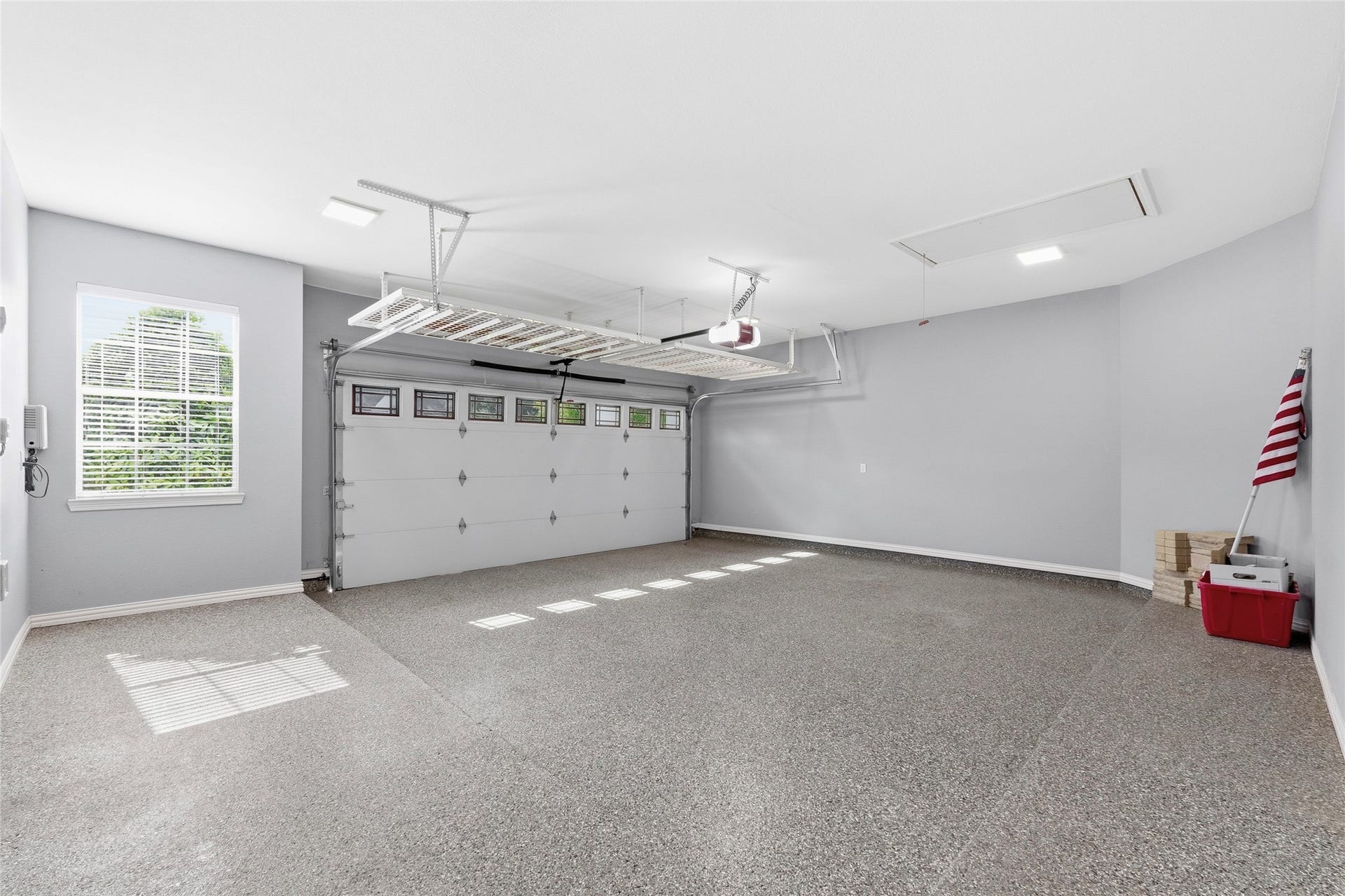 15314 Ledgewood Park Drive, Cypress, TX 77429 Spacious garage with a 5' extension, insulated garage door, accent windows, overhead storage, and Epoxy coating.