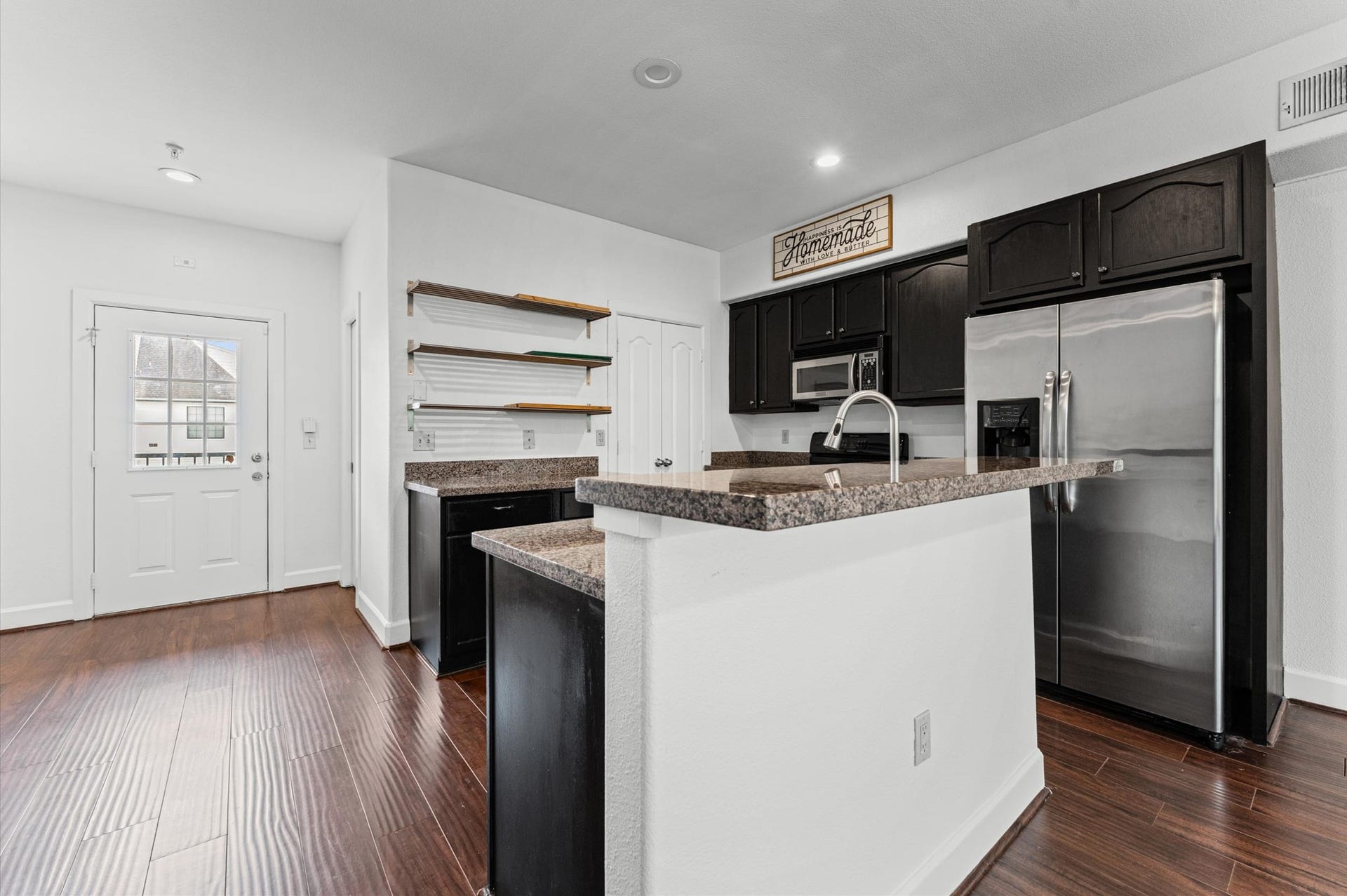 1602 Elgin Street, #10, Houston, TX 77004 The kitchen and living areas connect seamlessly, creating a comfortable, open feel throughout the unit's first floor.