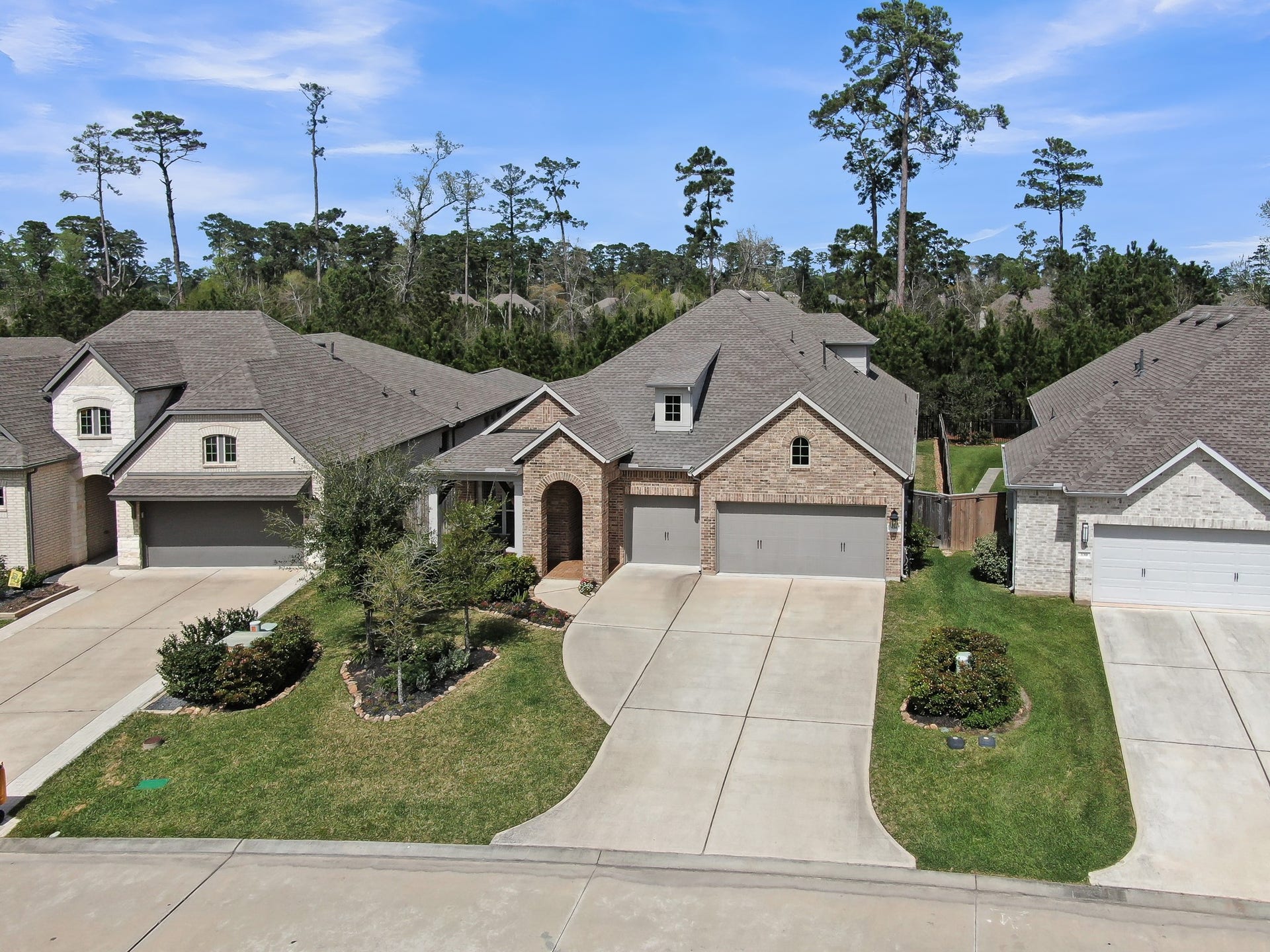 Ideally situated on a beautifully landscaped lot with a wide driveway, and serene wooded backdrop offering added privacy.