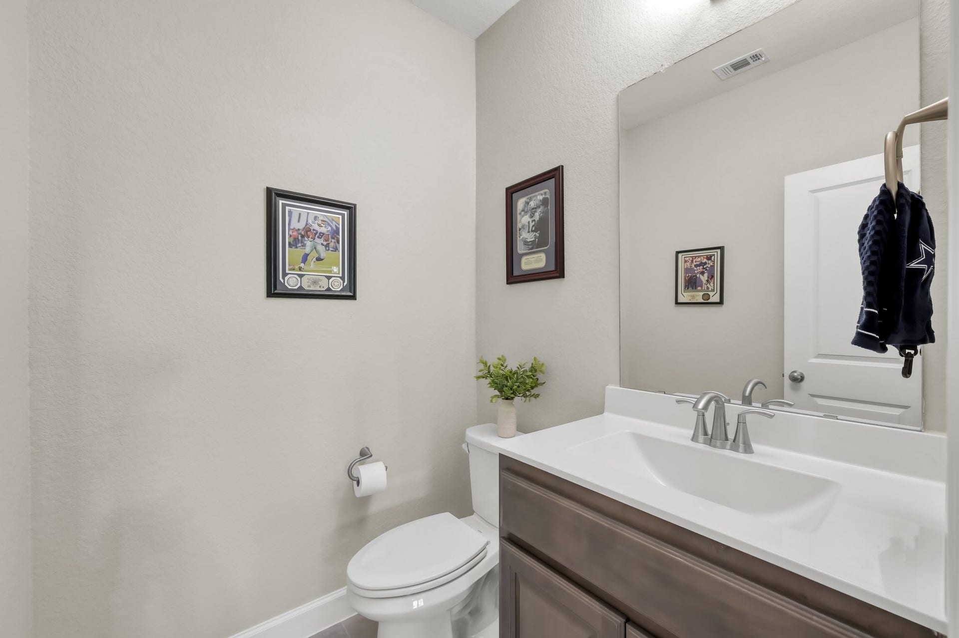 Convenient upstairs half bath with clean, modern finishesperfect for guests and game room access.