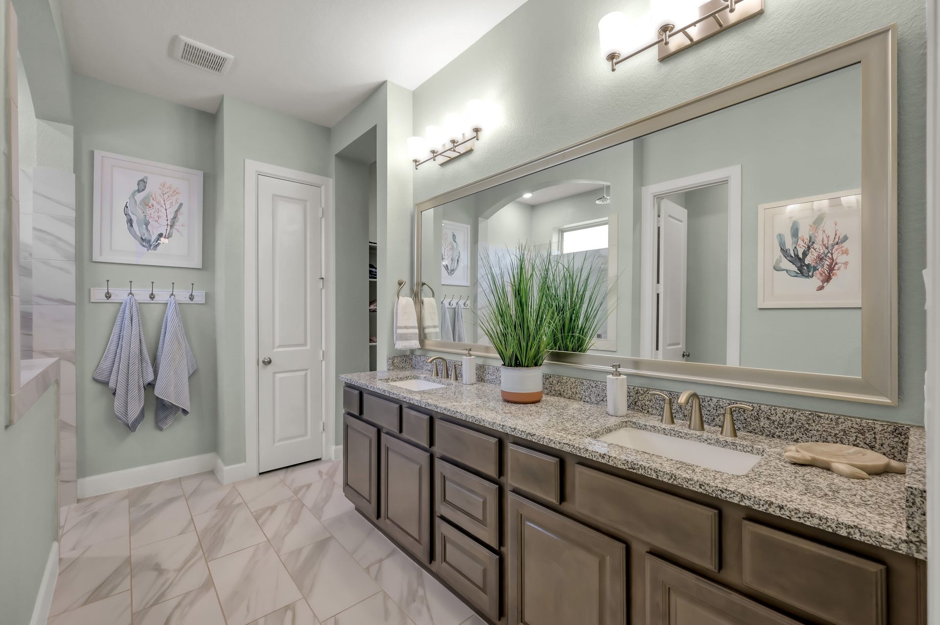 Primary bath with dual vanities, granite countertops, and ample storagedesigned for both comfort and functionality.