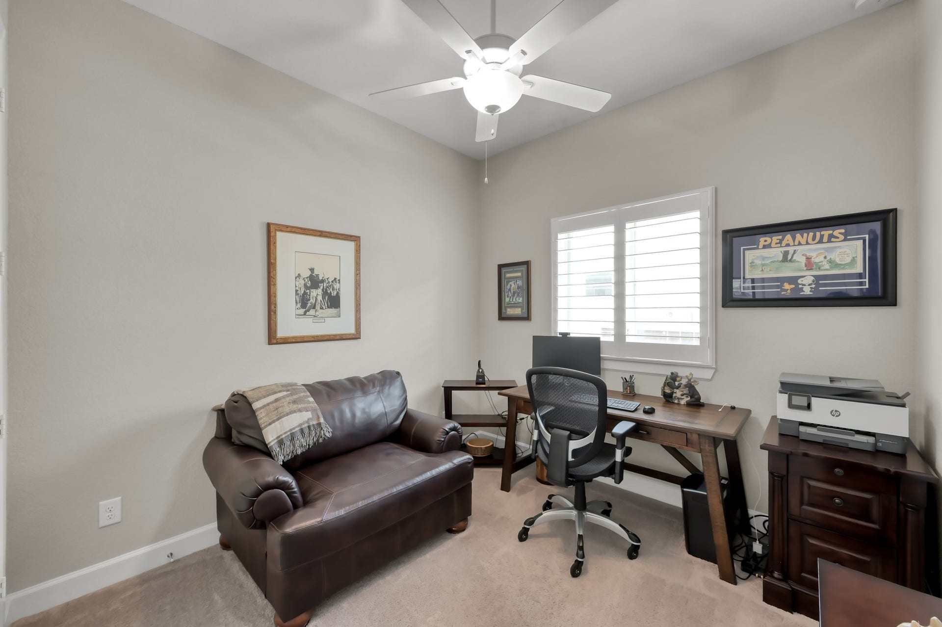 Versatile secondary bedroom currently used as a home office, featuring natural light, neutral tones, and flexible functionality.