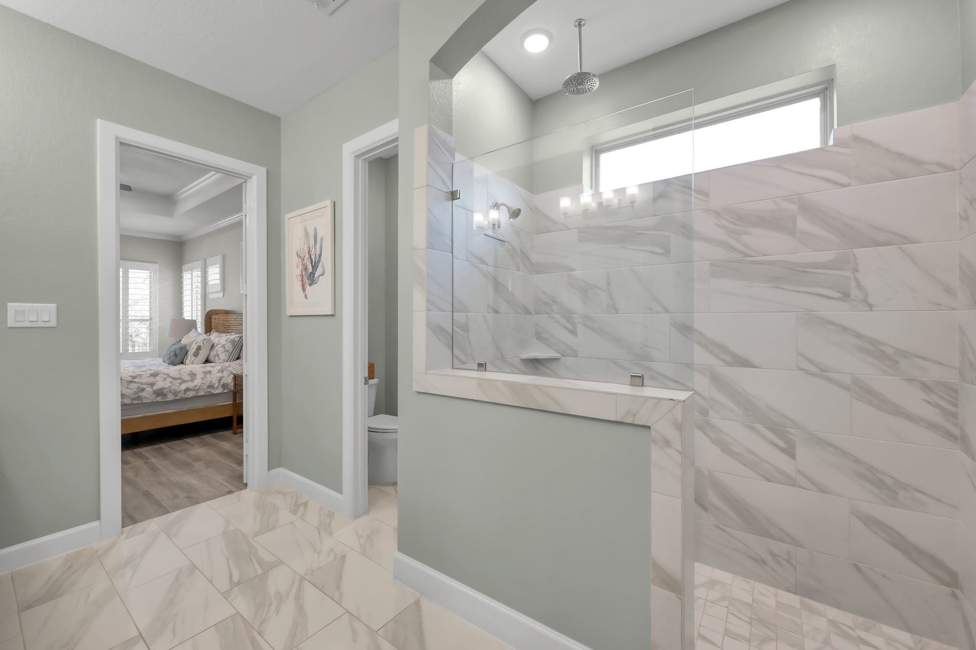 Spa-like primary bath featuring oversized walk-in shower with designer tile, glass enclosure, and modern finishes for a luxurious retreat.