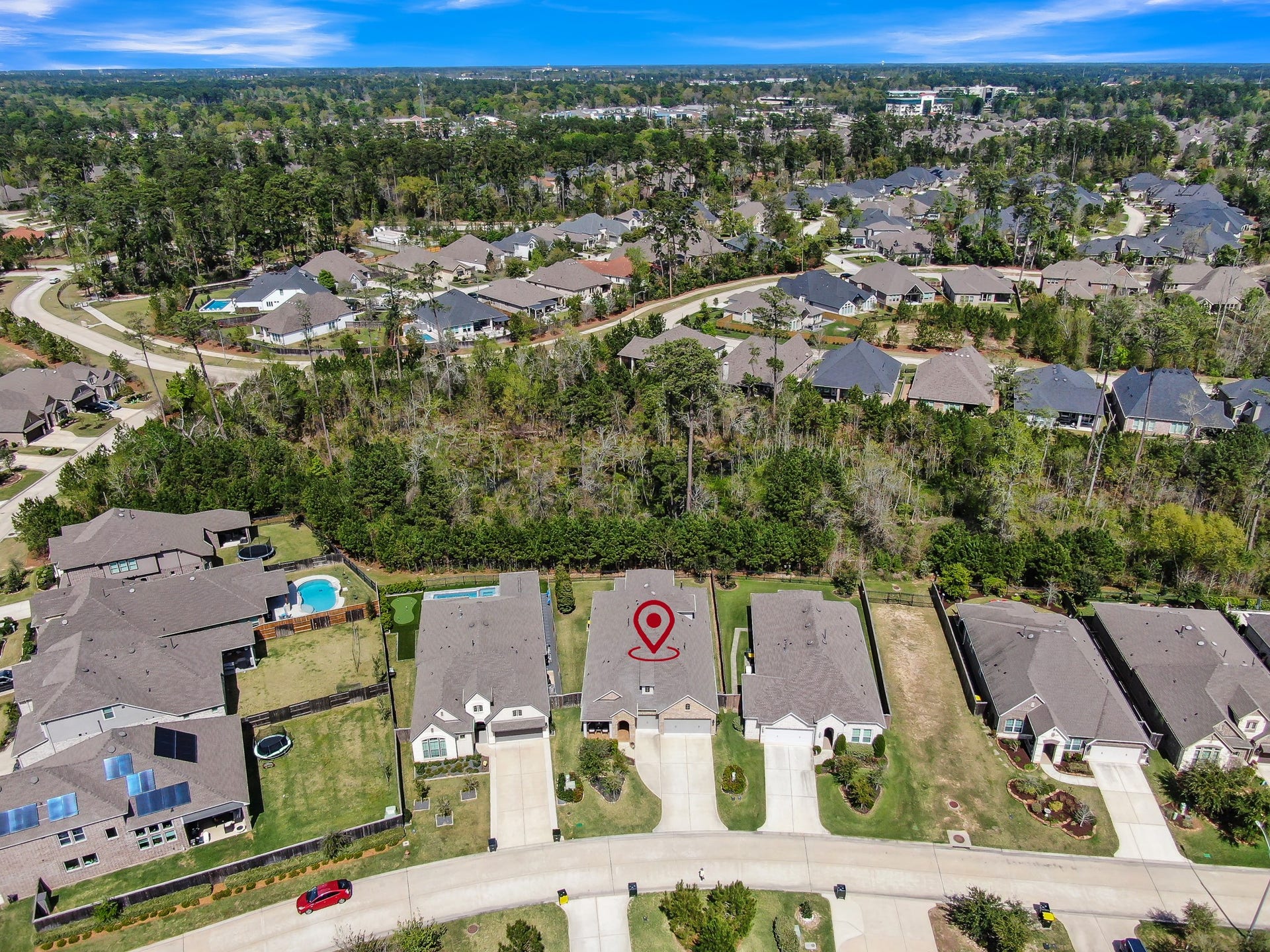 Aerial view highlighting the homes location within the neighborhood, showcasing nearby streets, surrounding homes, and the community setting.