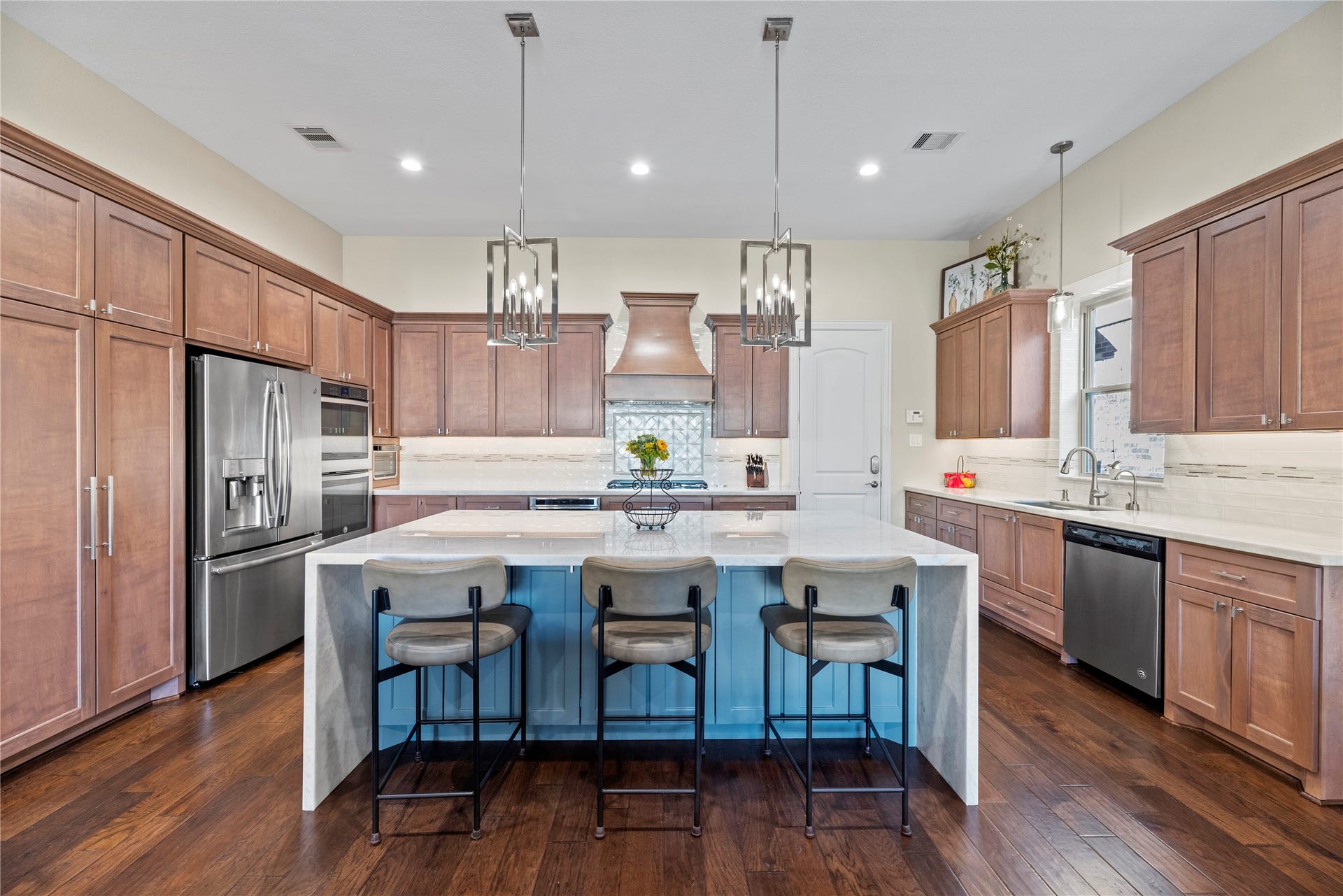 17922 Olde Oaks Estate Court, Cypress, TX 77433 The kitchen has a double oven, lowered microwave, and dishwasher.