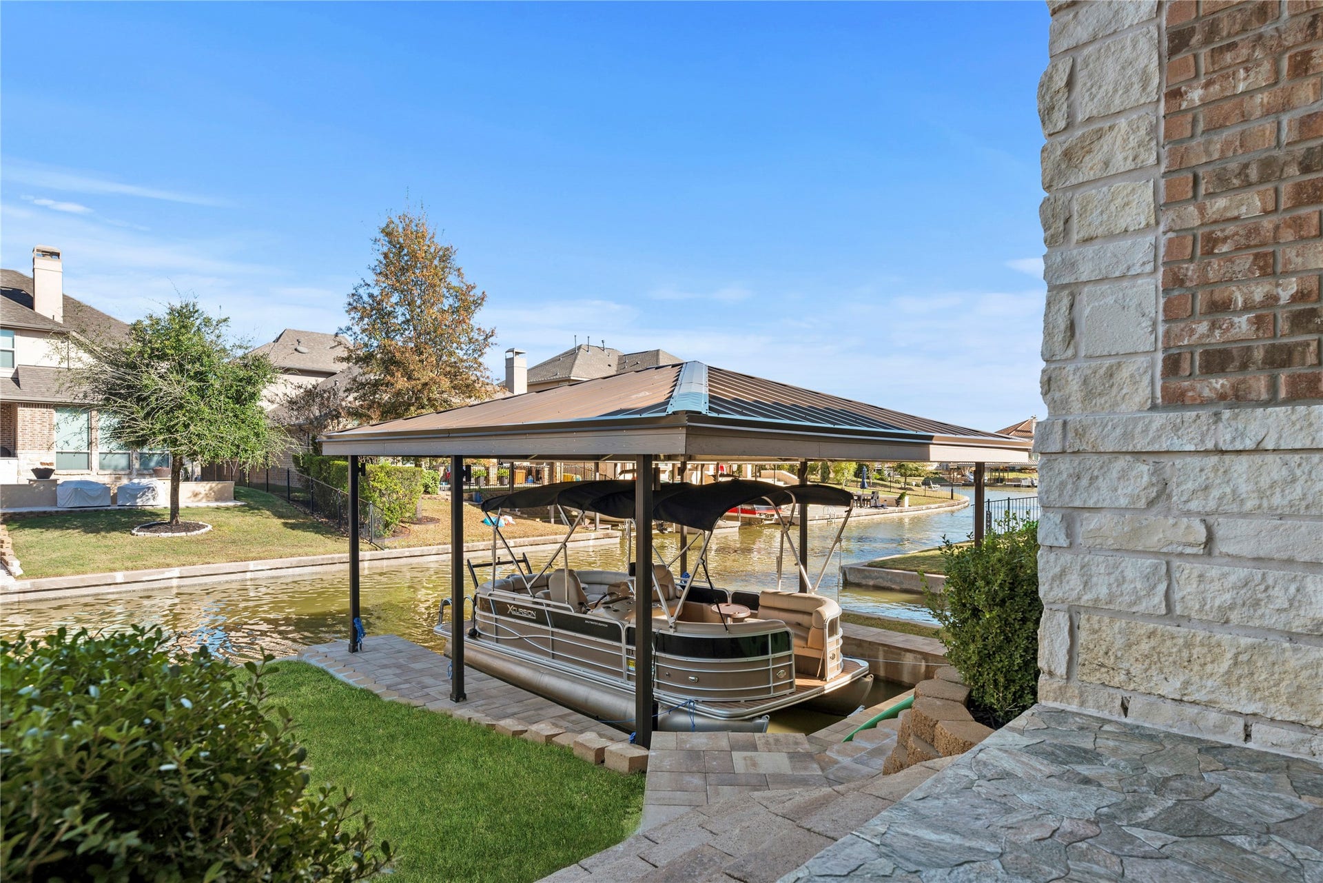 17922 Olde Oaks Estate Court, Cypress, TX 77433 In the backyard, this property features a private boat slip with a boat cover equipped with dusk to dawn custom lights.
