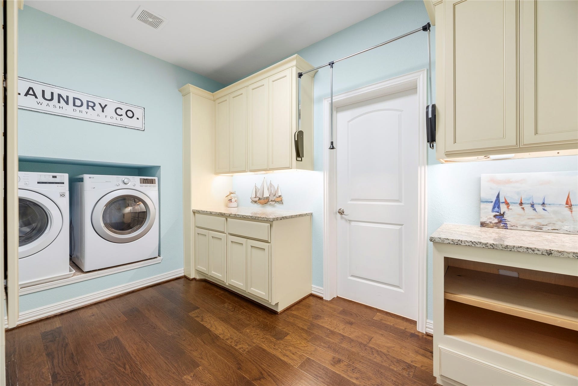 17922 Olde Oaks Estate Court, Cypress, TX 77433 Upstairs, this laundry room's cabinets, counters, and racks allow you to do all of your laundry in one spot.