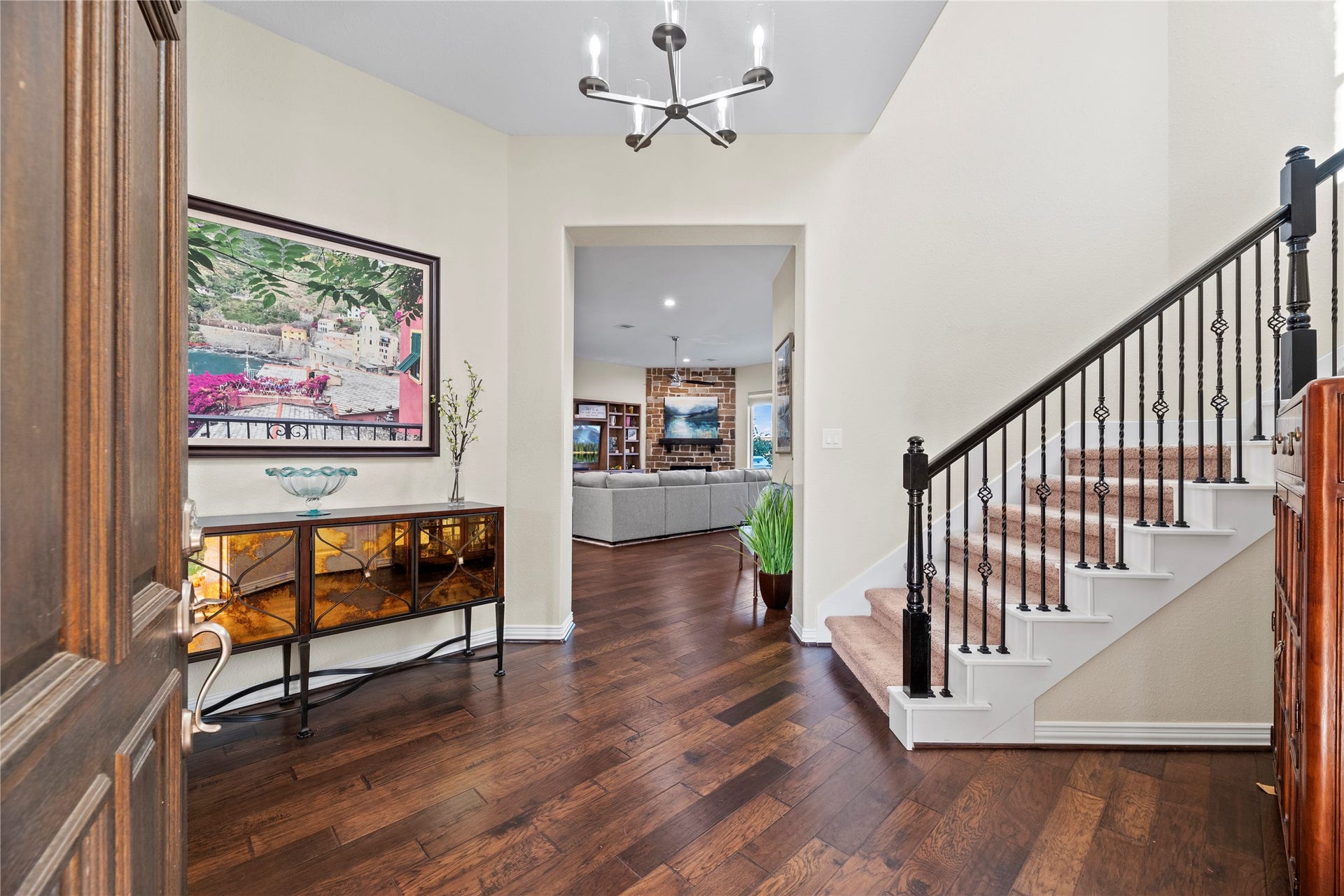 17922 Olde Oaks Estate Court, Cypress, TX 77433 Featuring beautiful hardwood floors and a wrought iron staircase, this foyer makes a magnificent welcoming statement to all who enter.