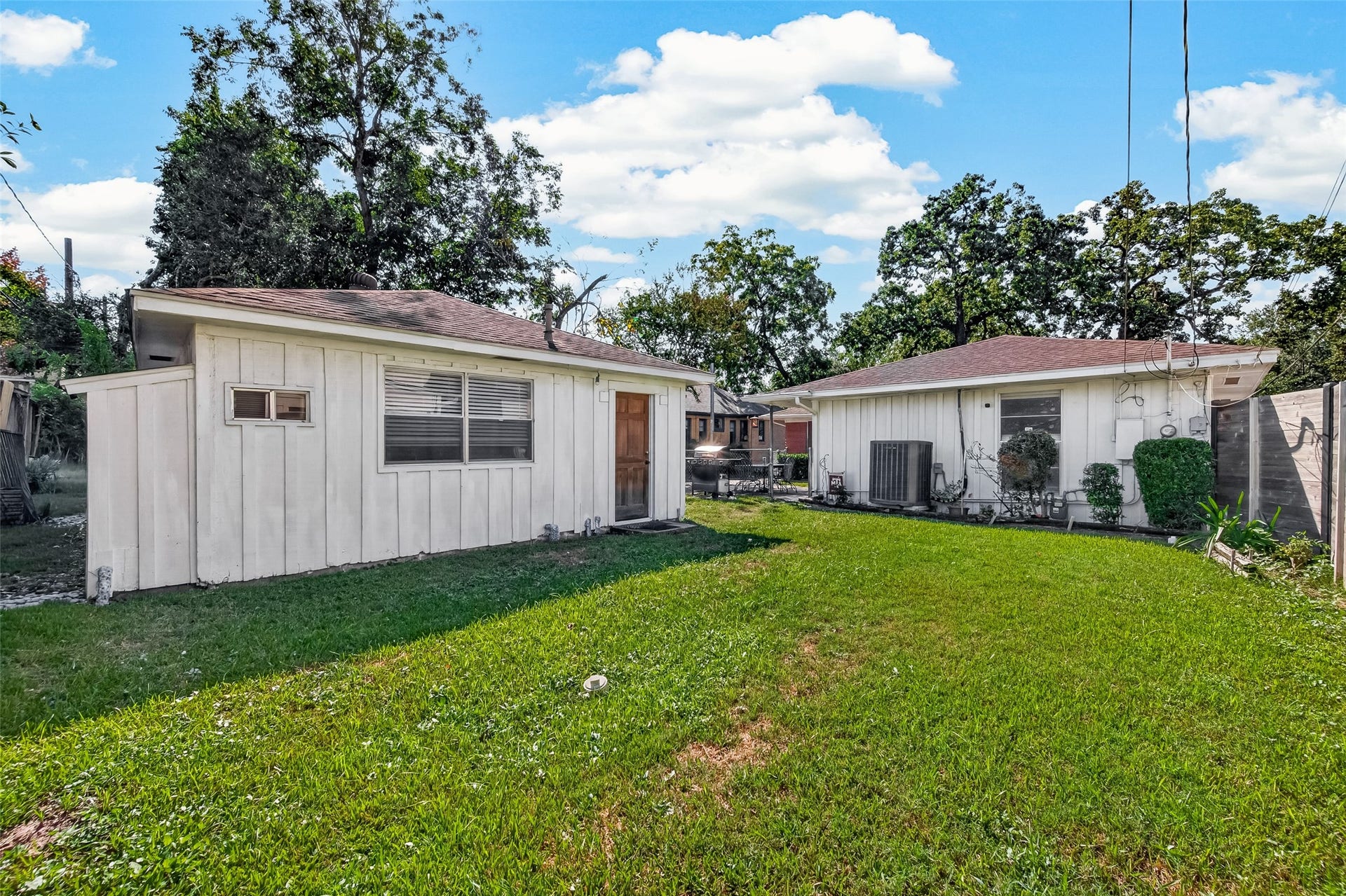 6655 Wildwood Way, Houston, TX 77023 Backyard. Side entrance to the garage, it is used now as a game room and has a half bath.