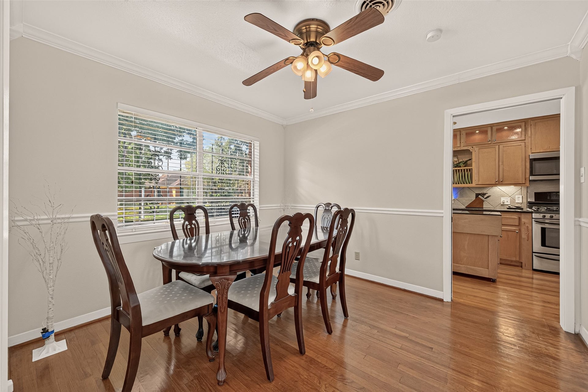 6655 Wildwood Way, Houston, TX 77023 Dining Room, with chair rail molding and the original hardwood floors.