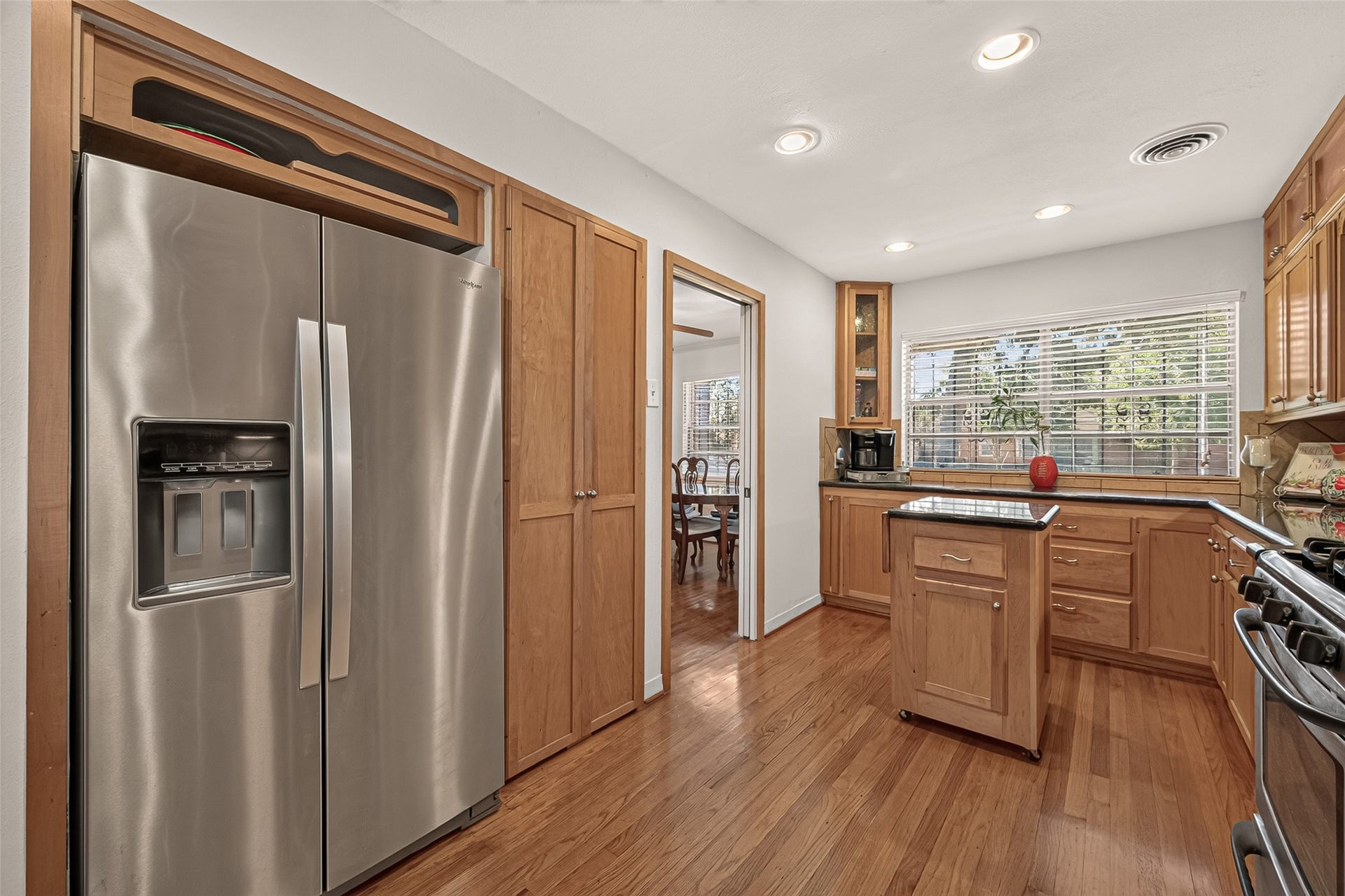 6655 Wildwood Way, Houston, TX 77023 Large double door pantry. Extra storage above the refrigerator for large serving platters. Natural light fills the kitchen from the large window above the counter space.